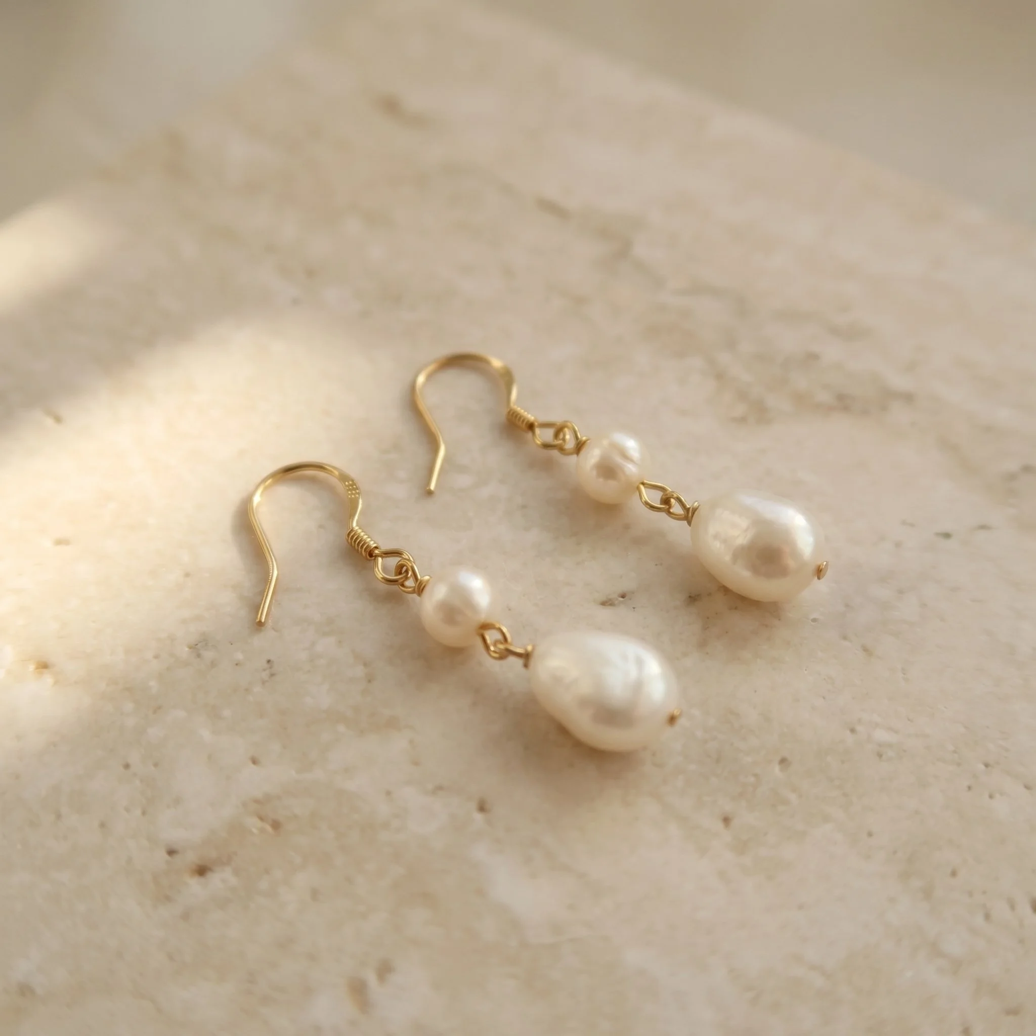 Gold plated freshwater baroque pearl earrings flat lay jewellery photography