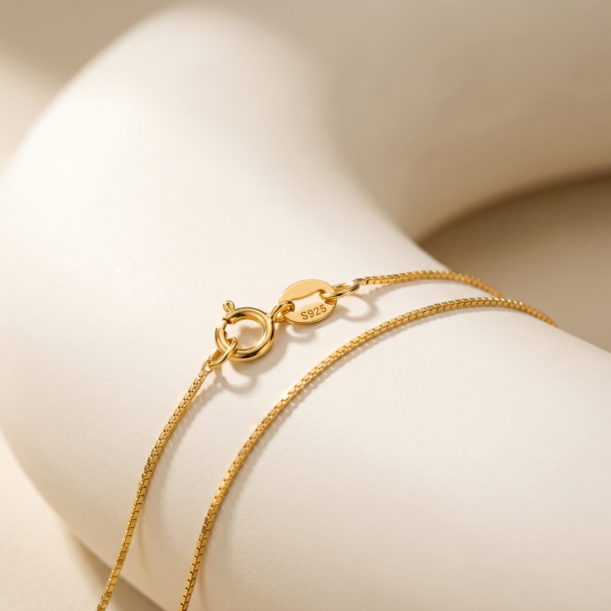 925 sterling silver clasp with hallmark detail on 18K gold plated pearl necklace.