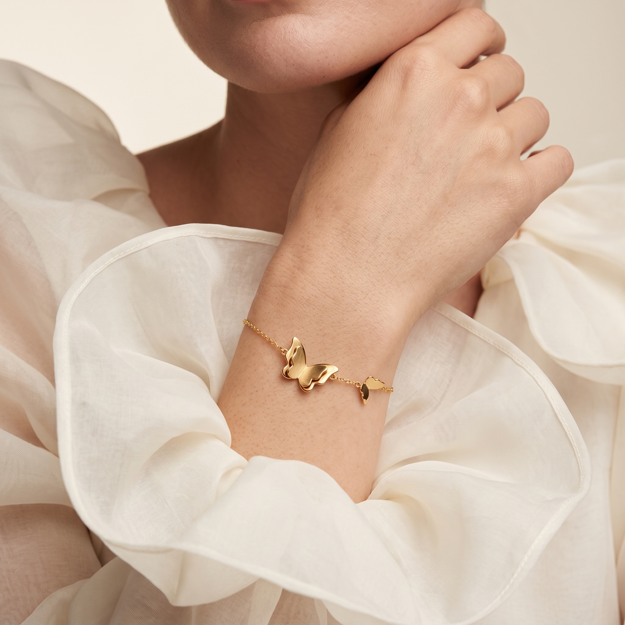 Woman wearing LAURRÈ butterfly bracelet in 925 sterling silver and 18K gold plating