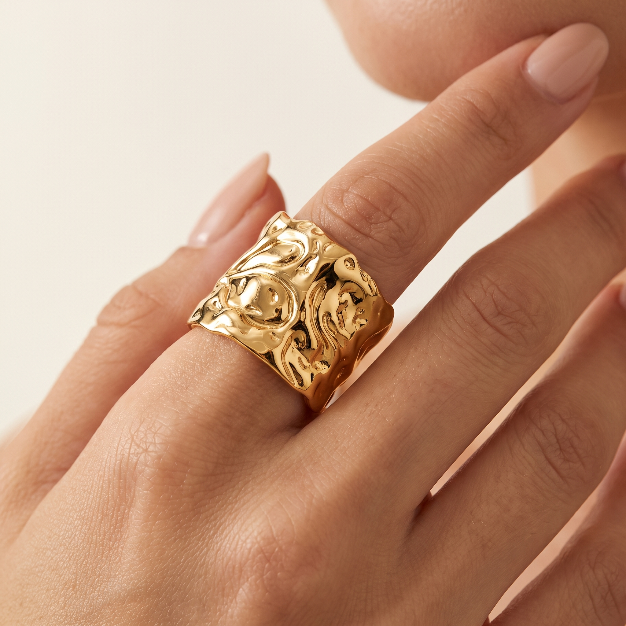 MOLTEN adjustable gold-plated statement ring worn on a woman’s hand, featuring a bold sculptural textured design