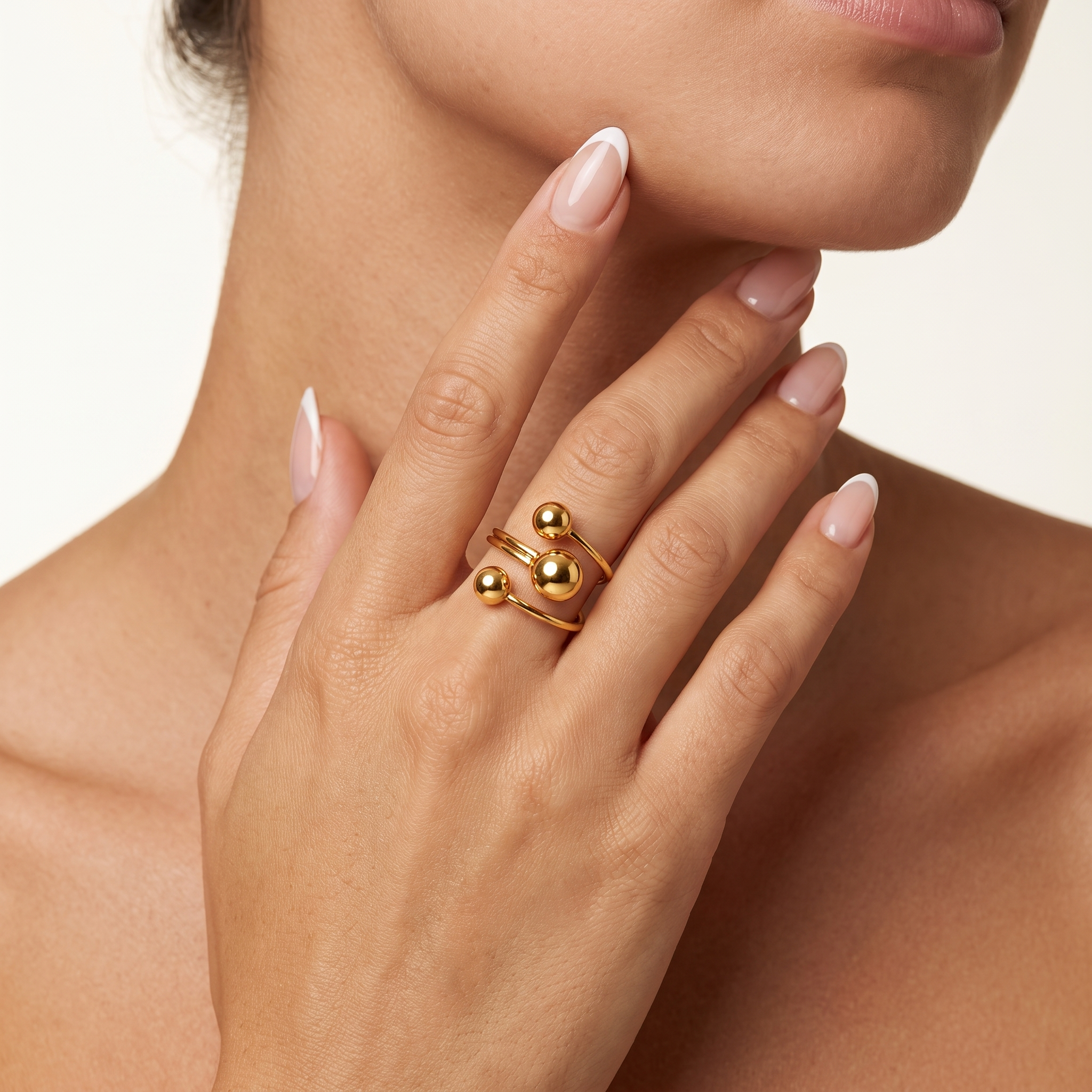 Woman wearing Orbelle 18K gold plated adjustable statement ring with three sphere design
