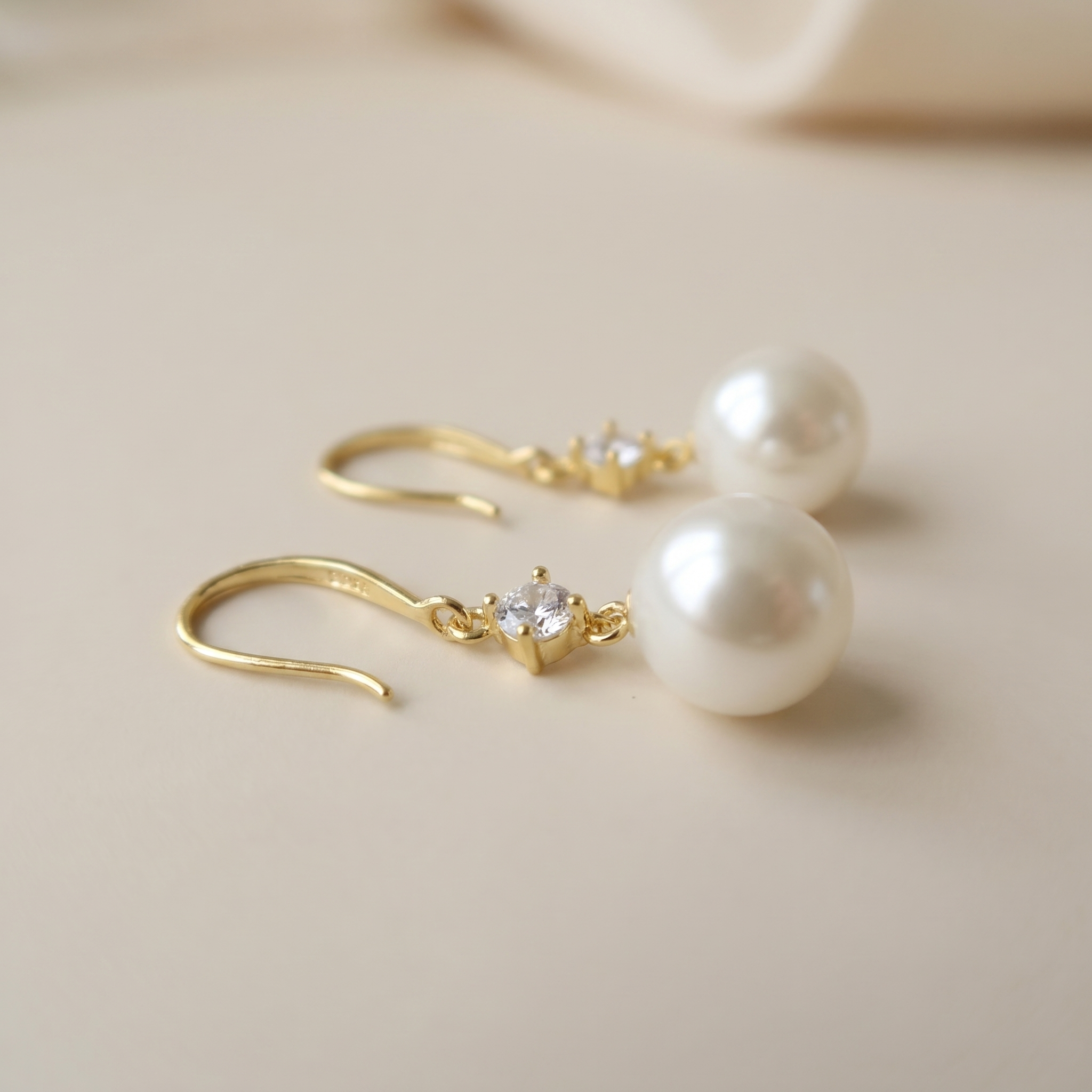 Close-Up of Gold Plated Sterling Silver Pearl Earrings with Sparkling Zirconia Detail
