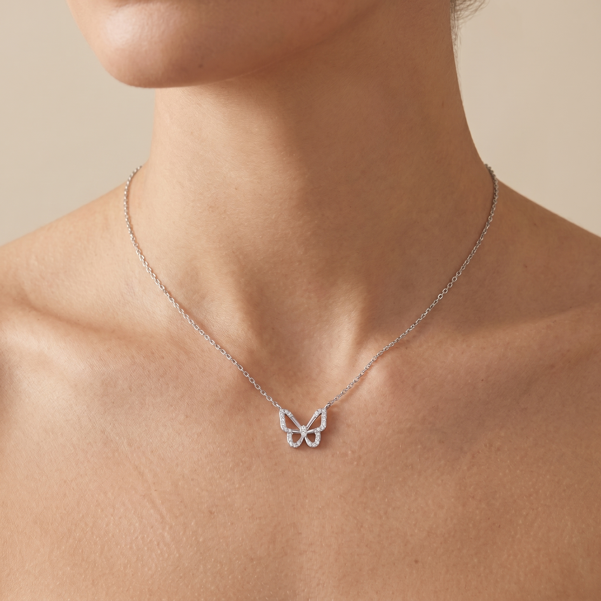 Woman wearing a 925 sterling silver butterfly necklace with sparkling AAA zirconia stones, minimalist everyday silver jewelry