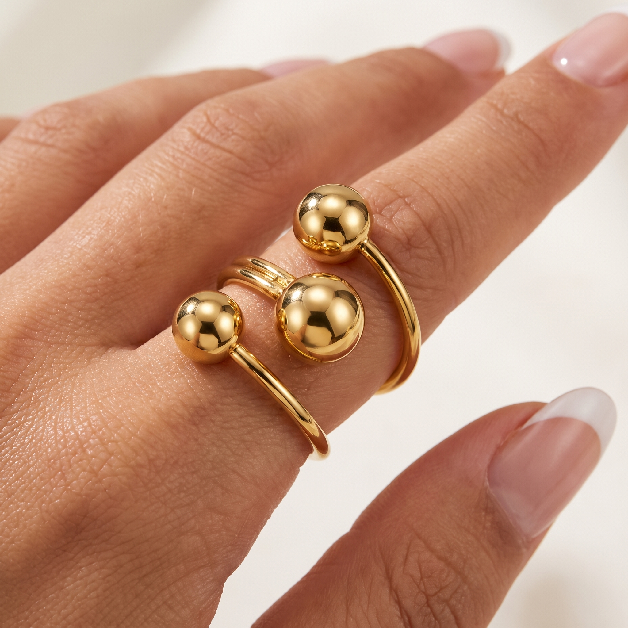 Close-up of Orbelle adjustable gold sphere ring in waterproof 18K gold plated stainless steel worn on hand