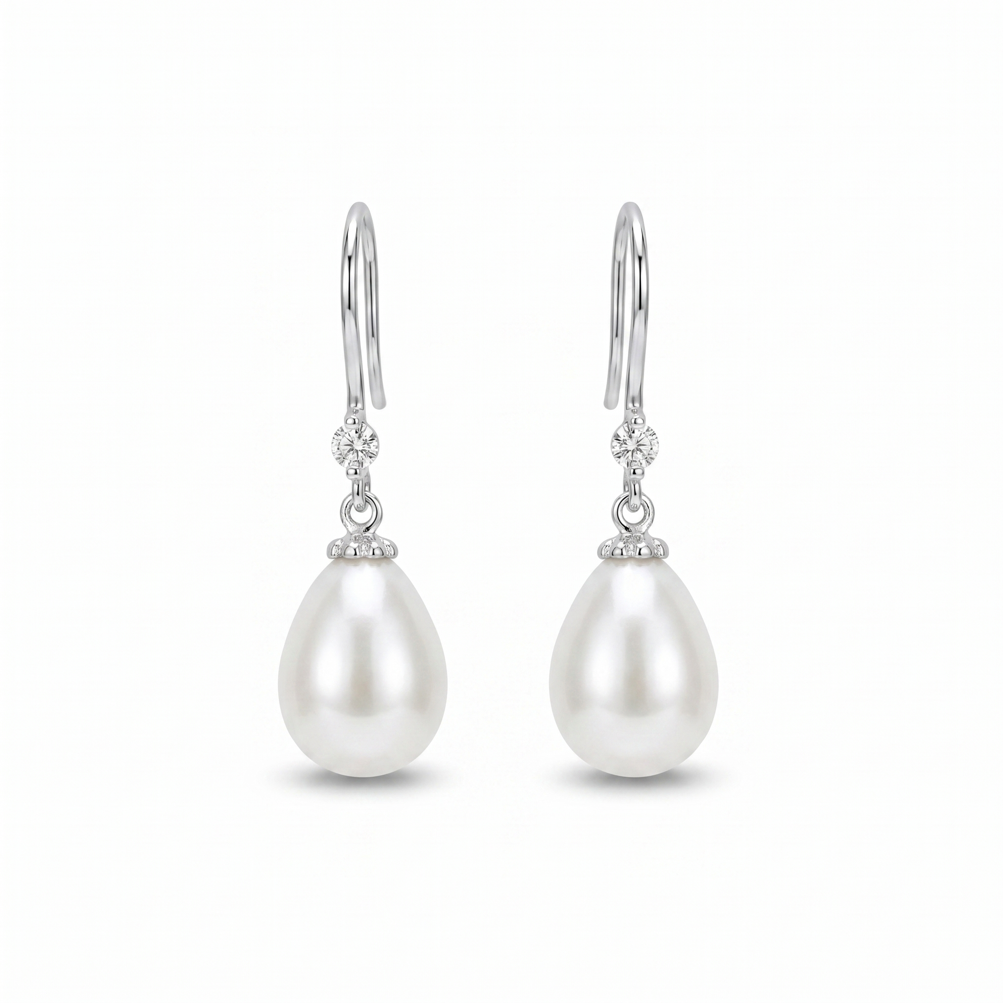 Woman wearing 925 sterling silver freshwater pearl drop earrings with sparkling zirconia accents, elegant bridal jewellery for weddings and special occasions