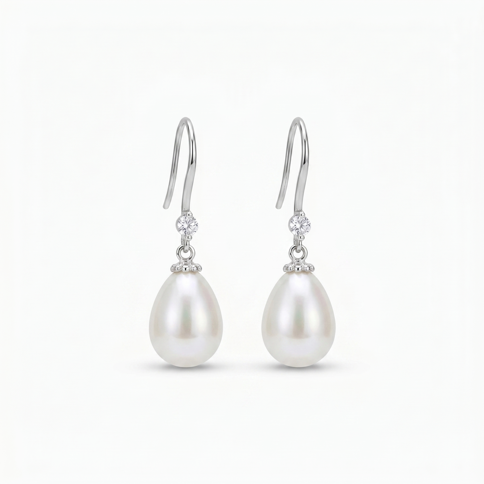 Close-up of 925 sterling silver pearl drop earrings featuring natural freshwater pearls and zirconia stones, worn by a bride