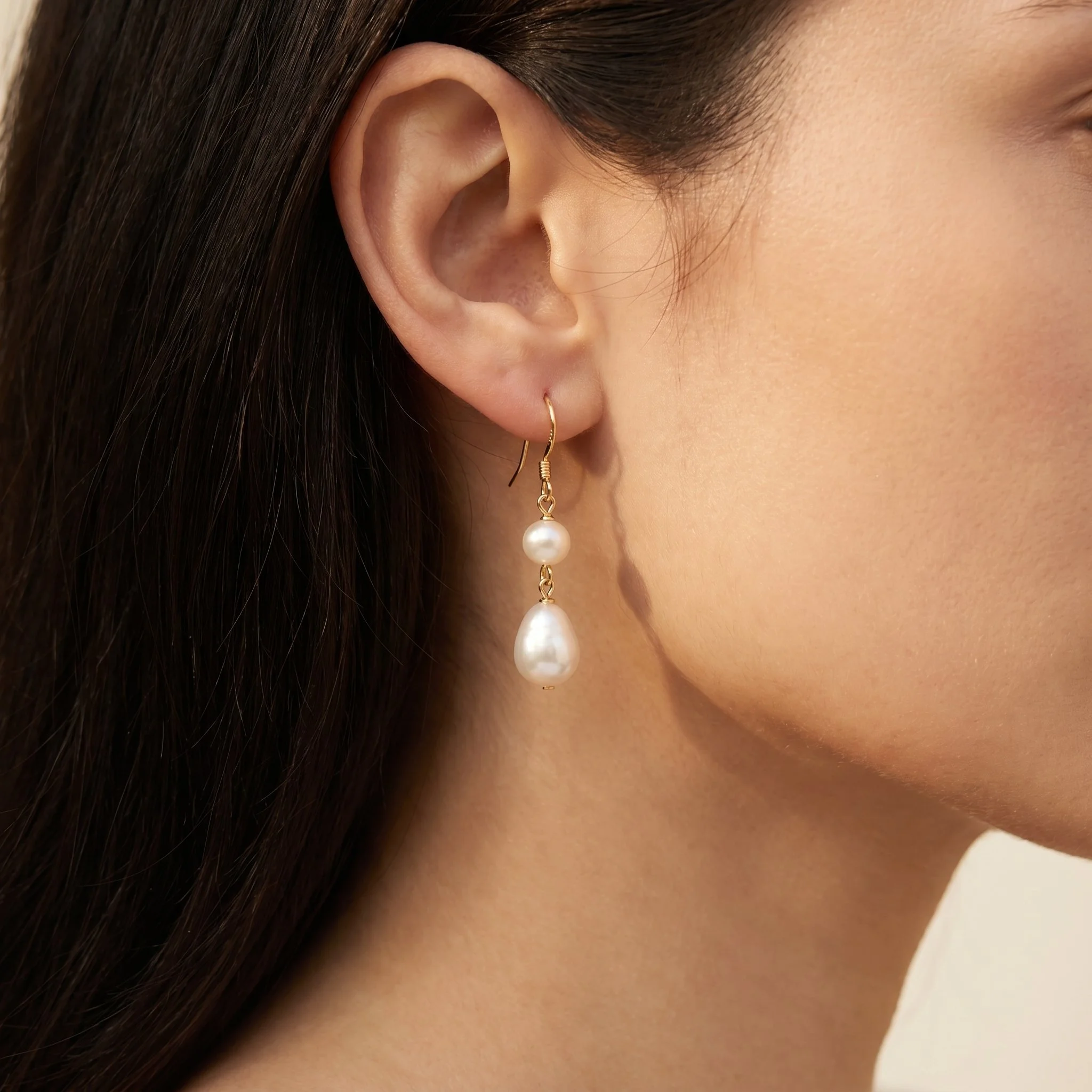 Bridal model wearing gold freshwater pearl drop earrings