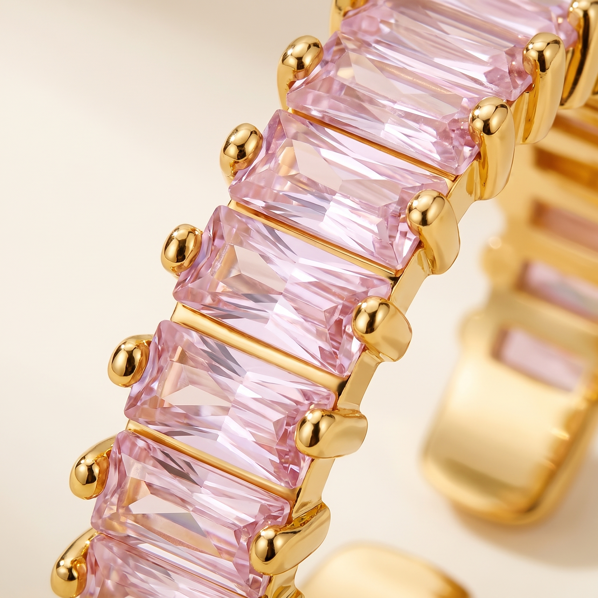 Close-up of pink cubic zirconia gold adjustable ring with rectangular stones – LAURRÈ