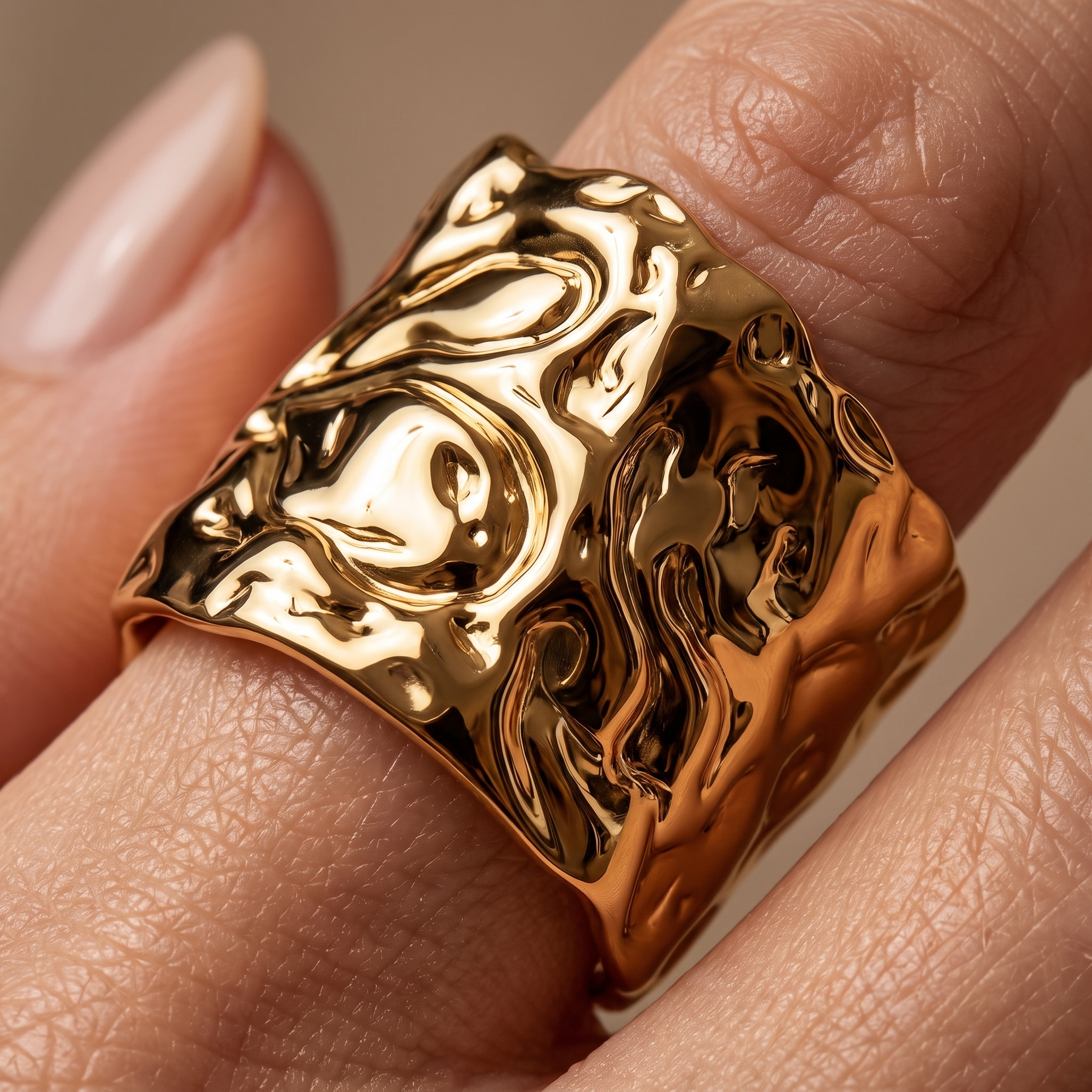 Macro close-up of MOLTEN PVD gold-plated adjustable ring showing polished sculptural molten texture and wide statement design