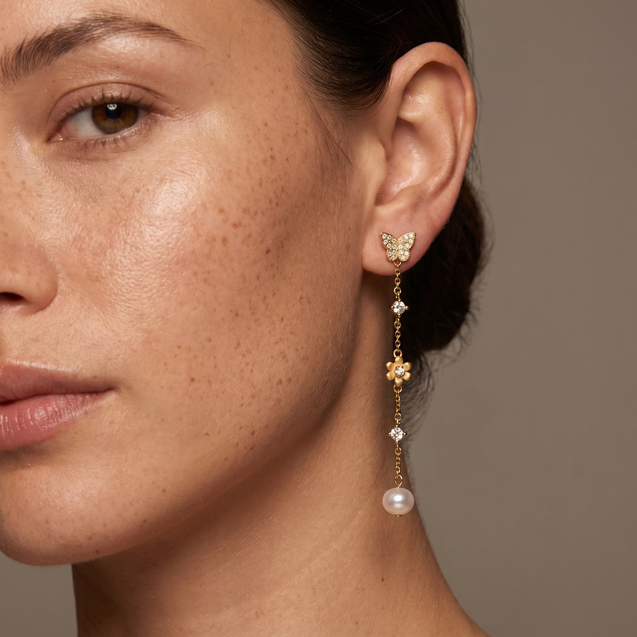 Luxury butterfly pearl earrings in 925 sterling silver and 18K gold plating shown on model, elegant bridal jewellery