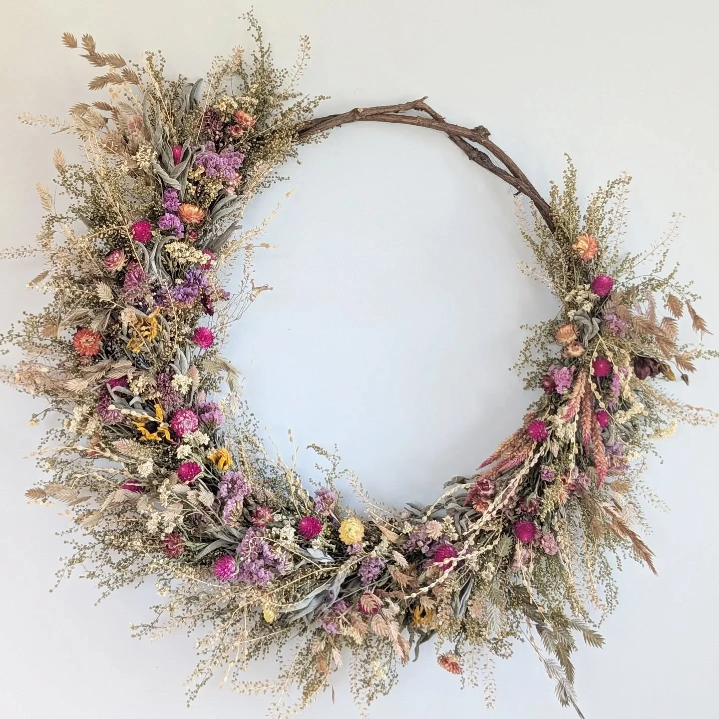 A year apart. The first photo was taken just about 12 months ago. A year later this wreath still hangs on my own wall, a little faded, a little droopier and missing some pieces I stole to plant in the field (next season I should have enough green dra