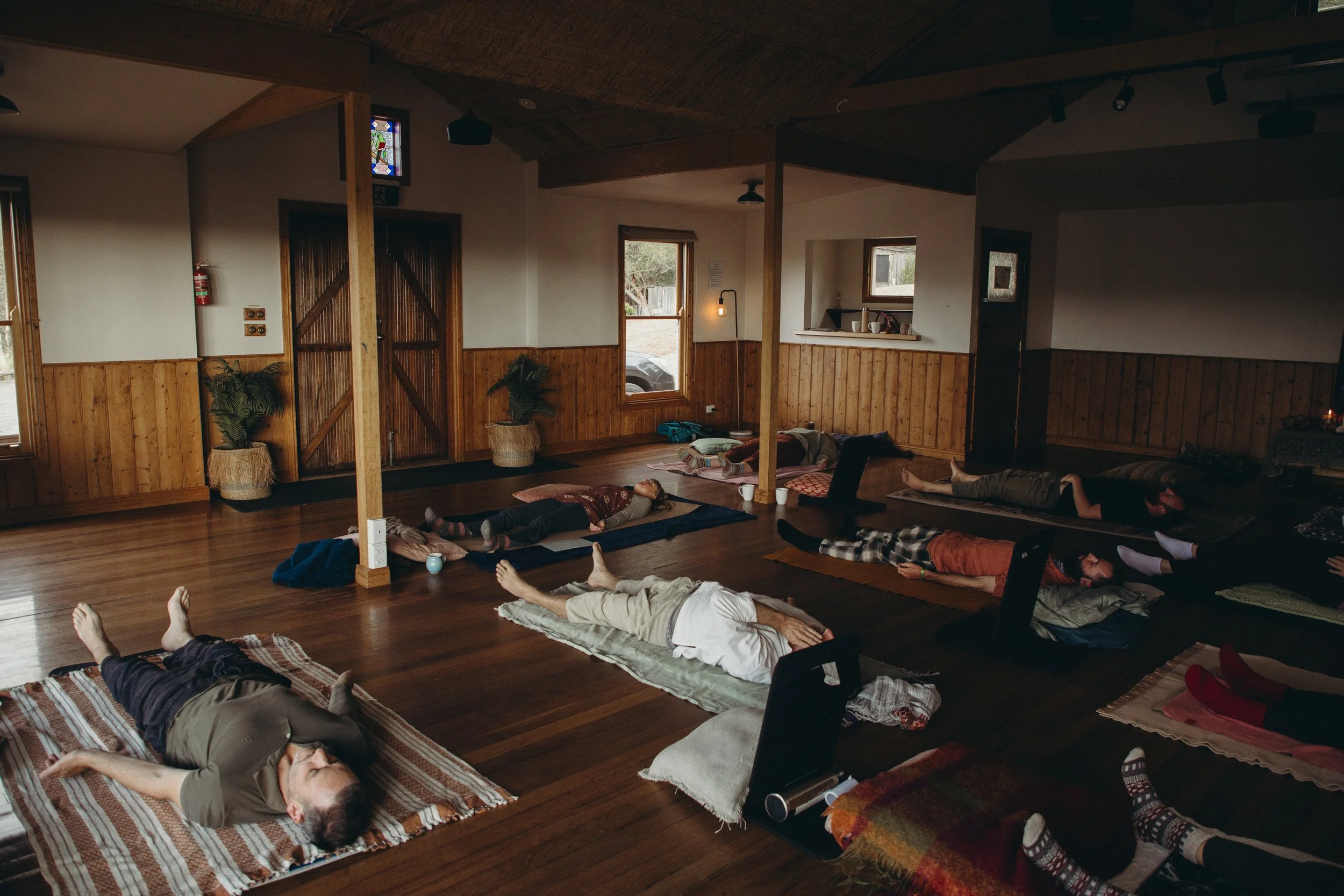 Group resting in savasana following a Vedic rounding practice.