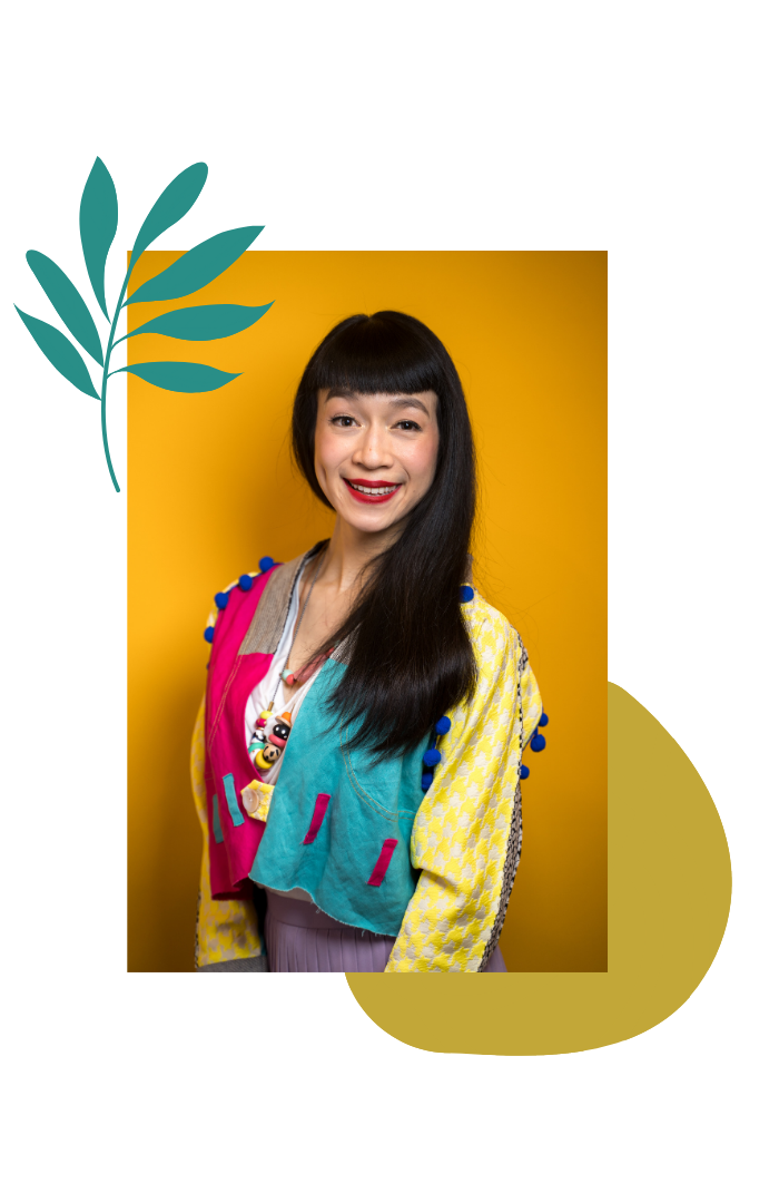 A young woman with straight black hair and bangs, wearing colorful clothing with a yellow background.