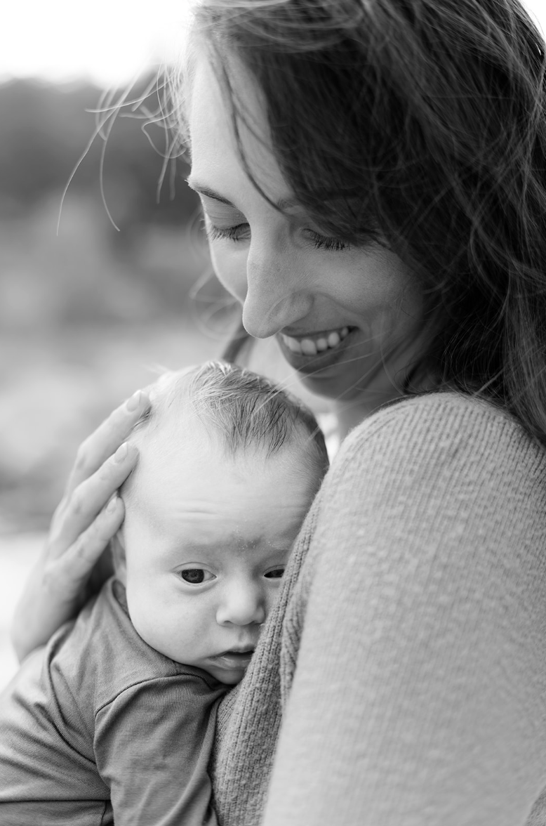 Mother holding newborn during photo session in Loveland, CO