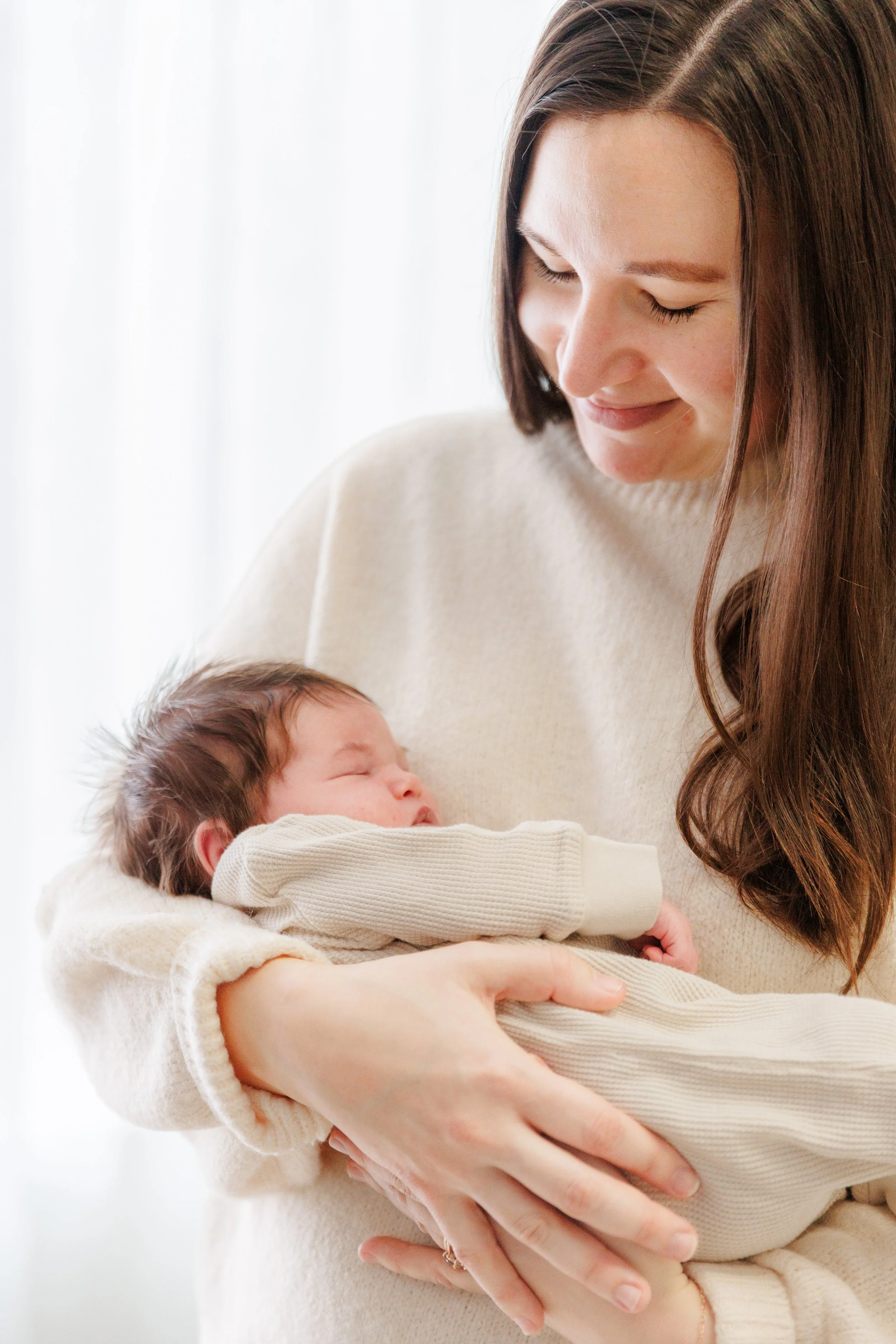 Mother holds baby during a newborn photography session near Fort Collins, CO