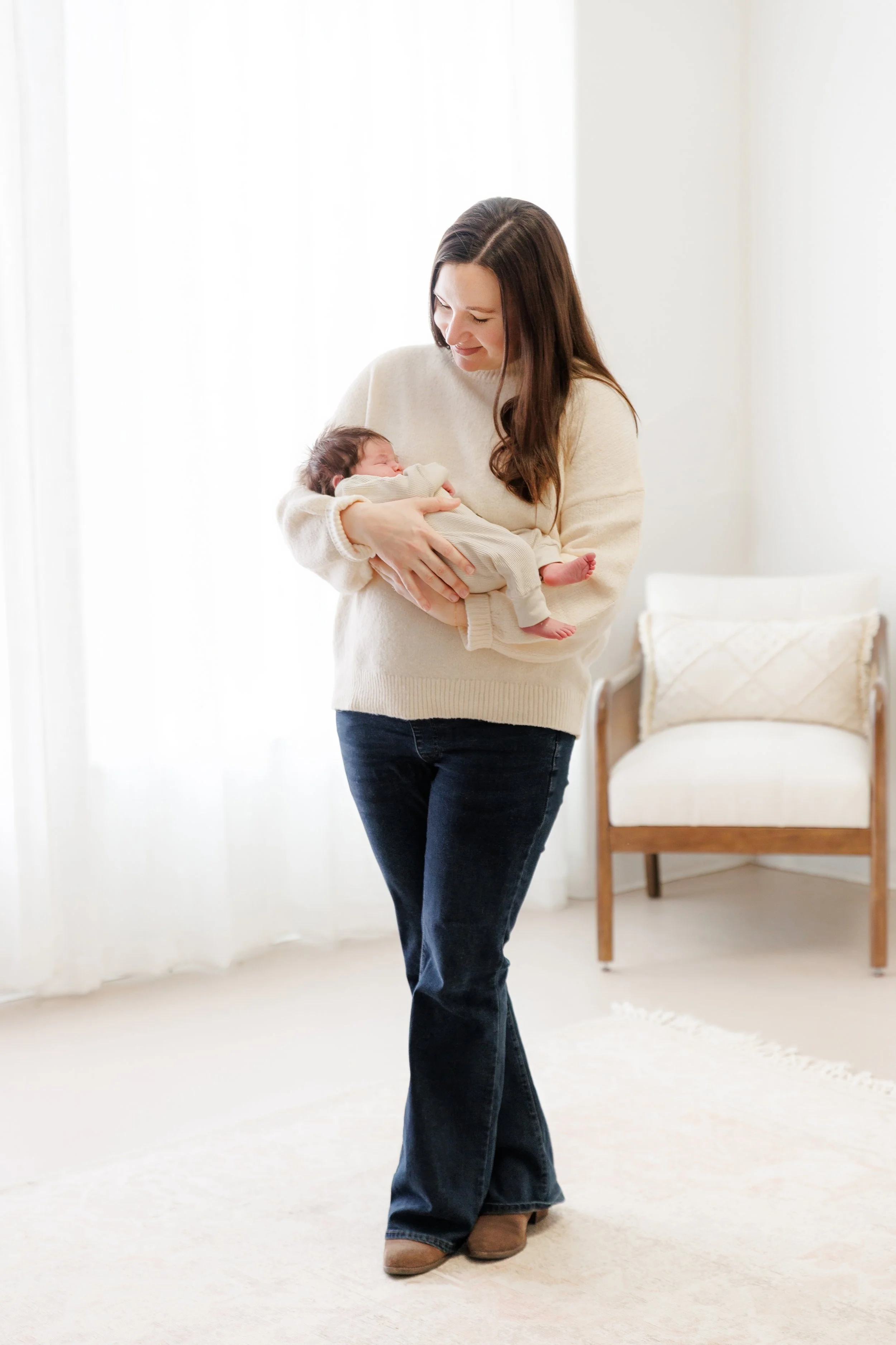 Mother holds baby during a newborn photography session near Fort Collins, CO