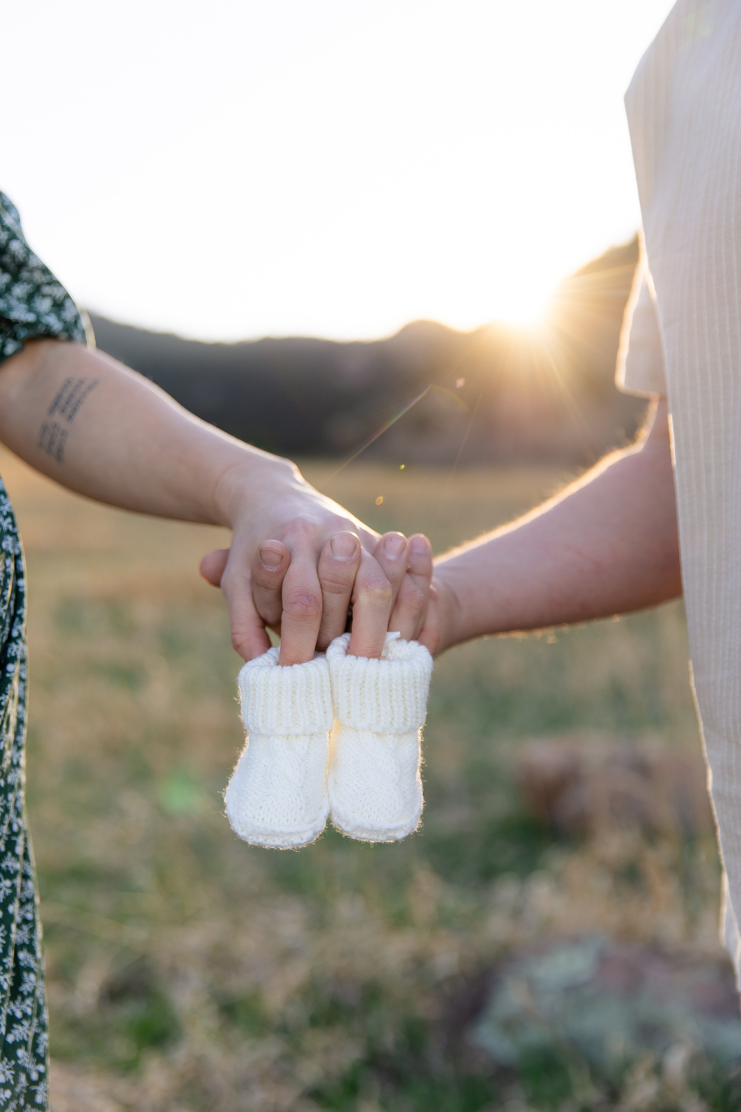 Baby shoes during golden hour maternity photoshoot in Boulder