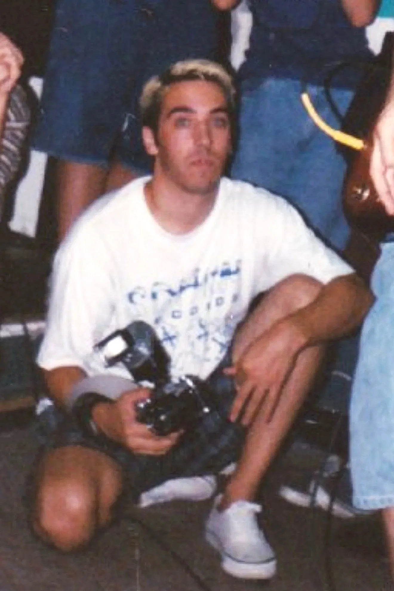 Embarrasing photo of Adam Tanner from 1993 with bleach blond hair holding his camera.