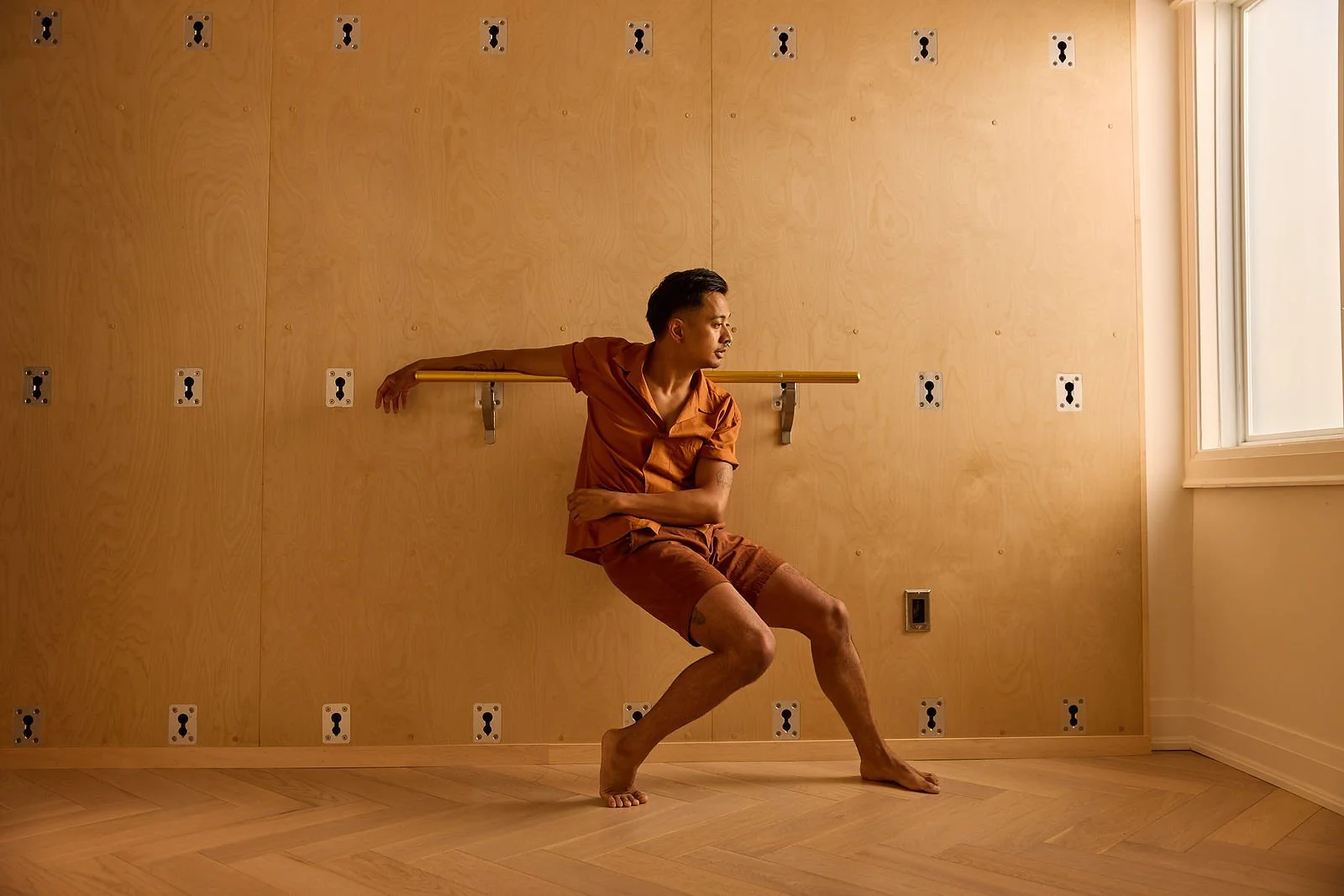 Person resting at the Barre during a Barre Class at SEQUINS Studoi in Toronto