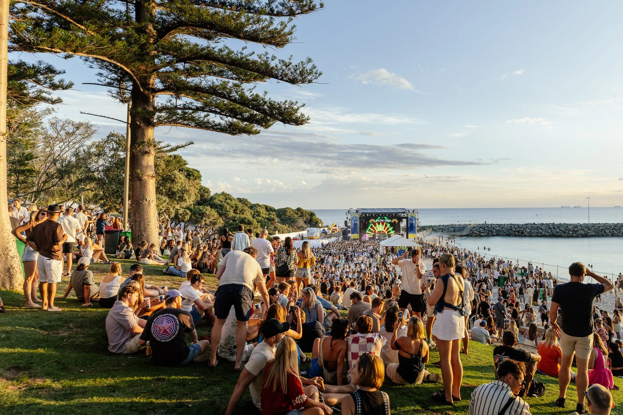 ELECTRIC ISLAND EVENT 2026 | Crowd of people gathered and enjoying the atmosphere at the Electric Island Dance Music Festival by the Beach.