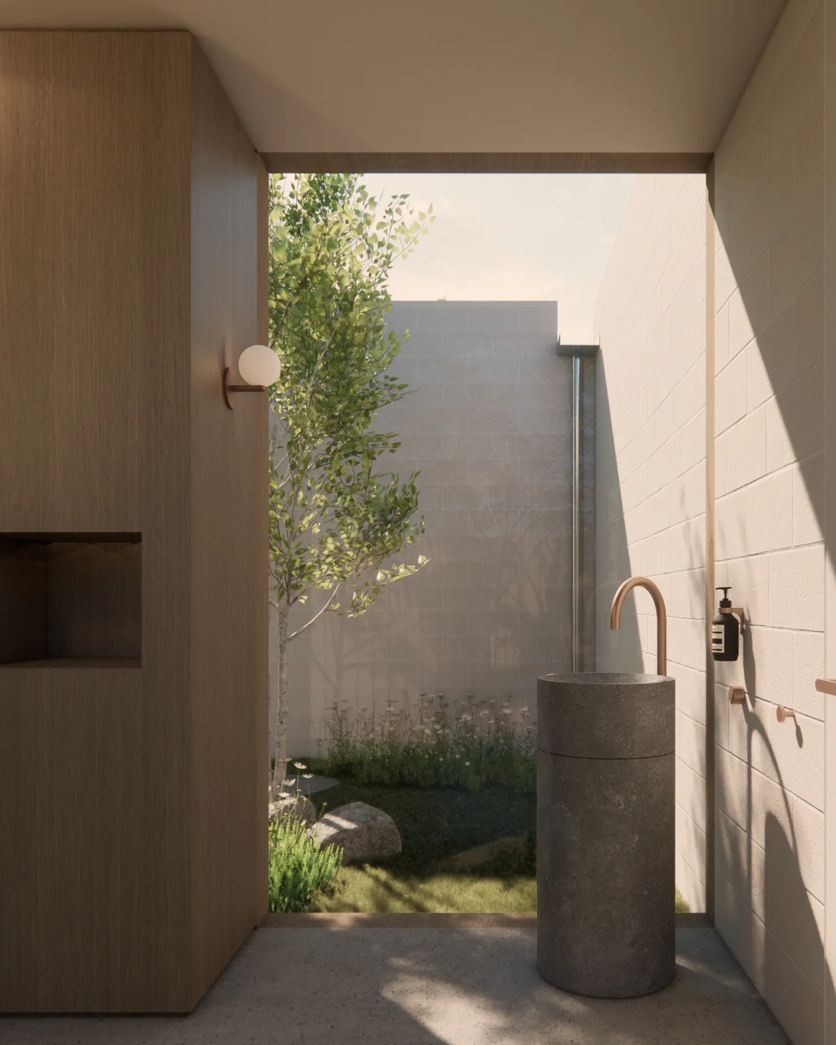 Contemporary powder room with a stone pedestal basin, looking onto a green courtyard enclosed by concrete block walls. 
