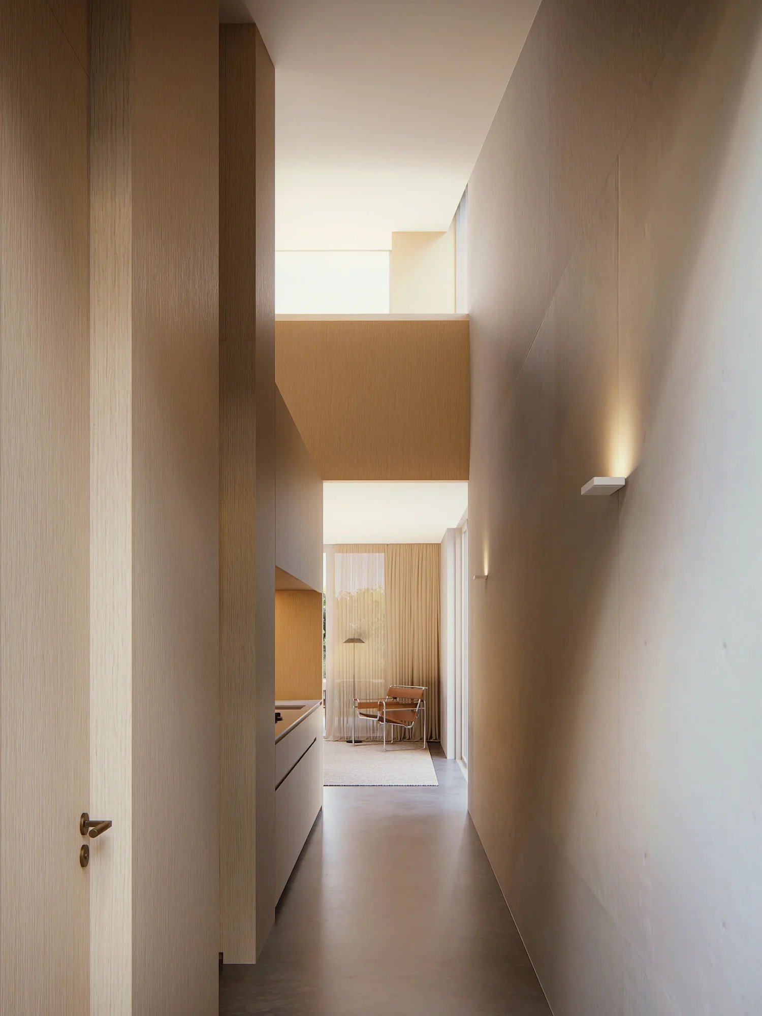 Double height living space formed of concrete and timber