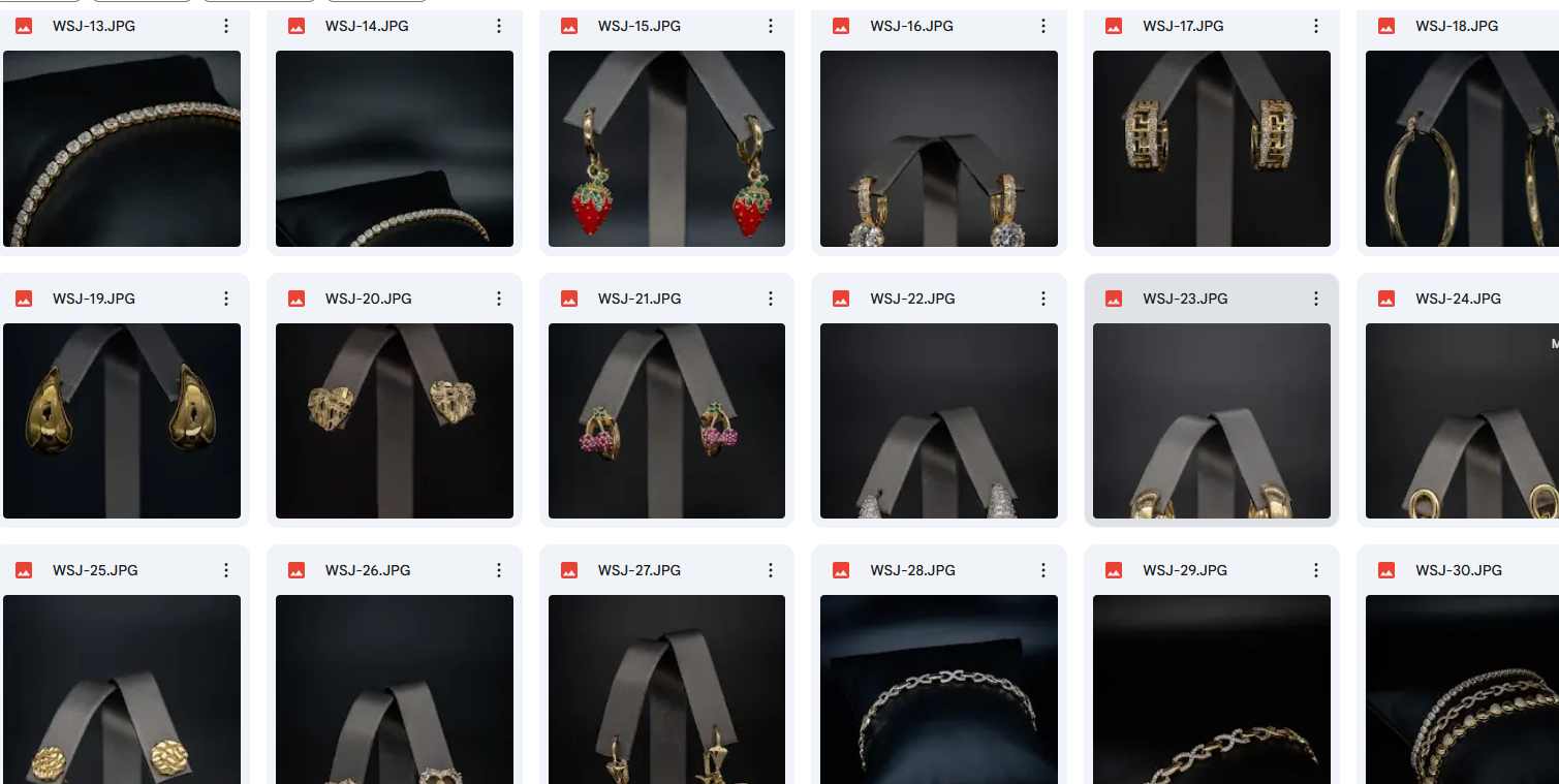 A collection of jewelry displayed on black stands, including earrings, necklaces, and bracelets, featuring gold, silver, and diamond designs.