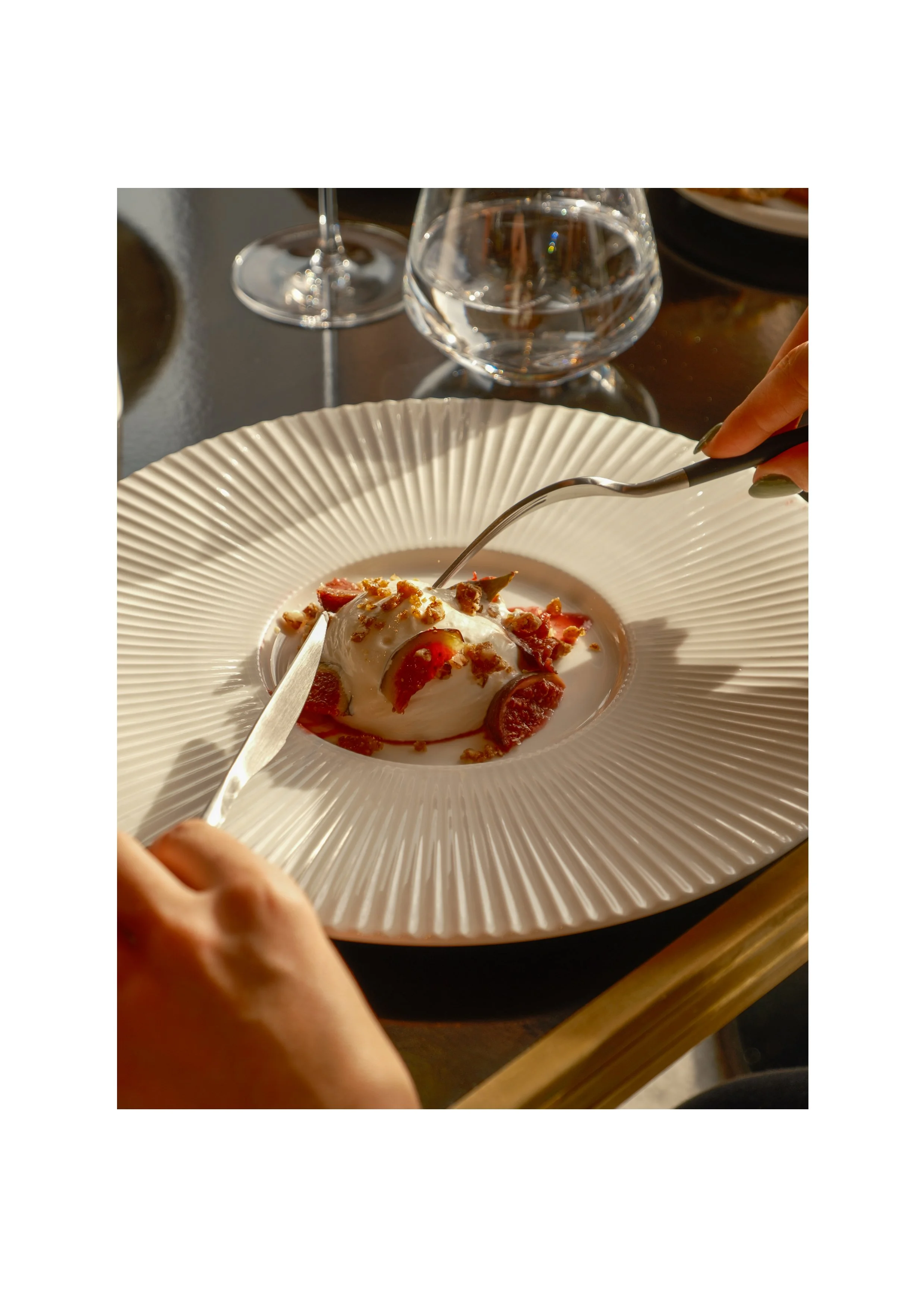 Detail of a fig dessert with whipped cream, editorial lifestyle photography shot on Fujifilm.