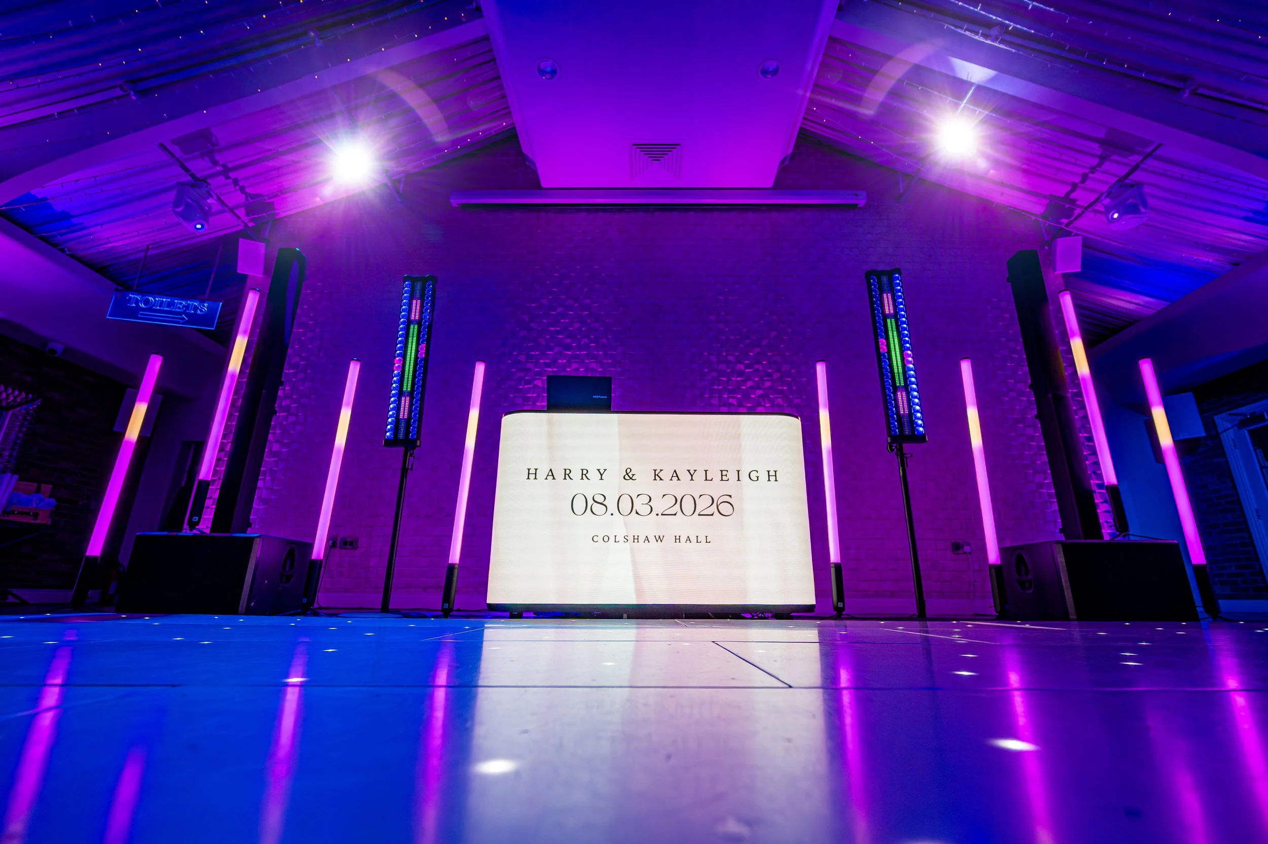 Personalised LED DJ booth displaying a couple’s names and wedding date at Colshaw Hall