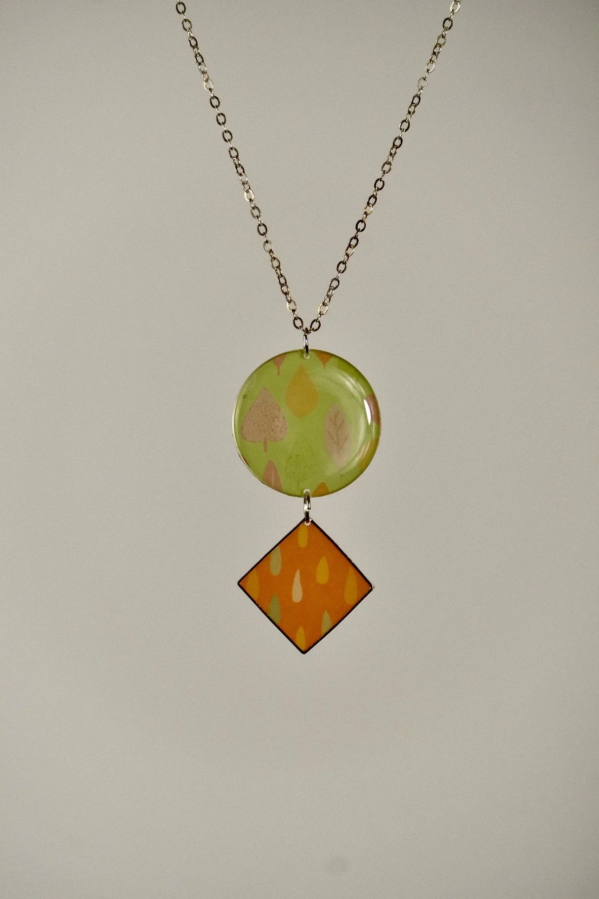 indigo roc abstract orange and lime resin necklace