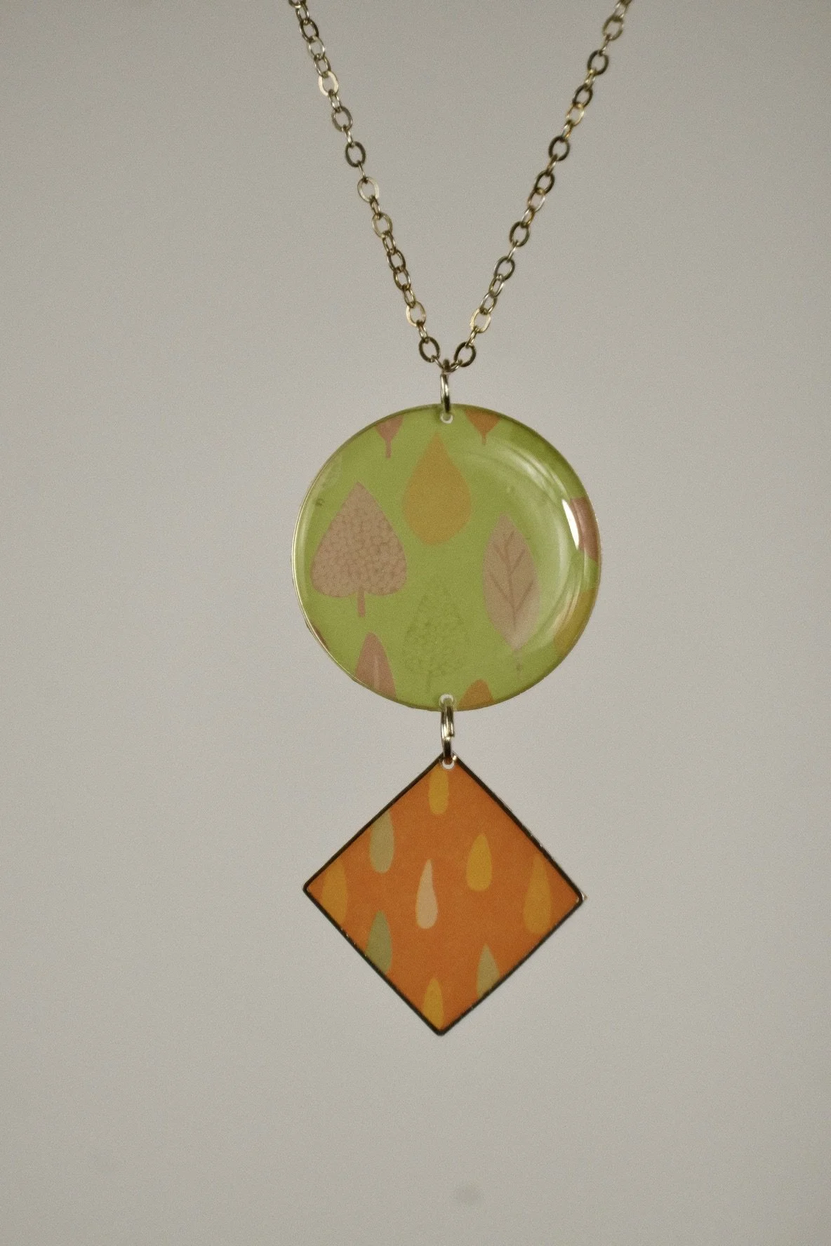 indigo roc abstract orange and lime resin necklace