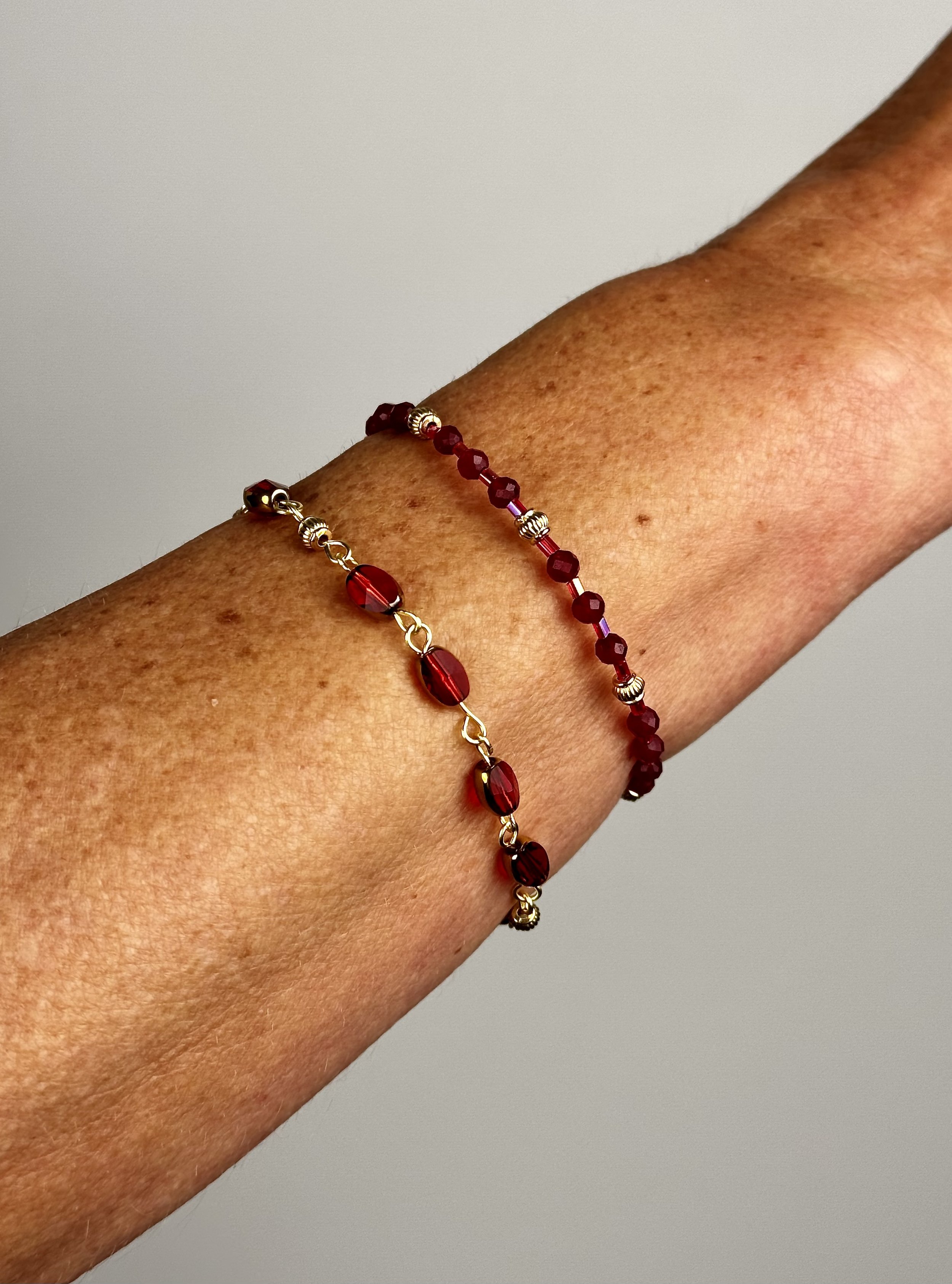 stacked open red berry bracelet with other collection