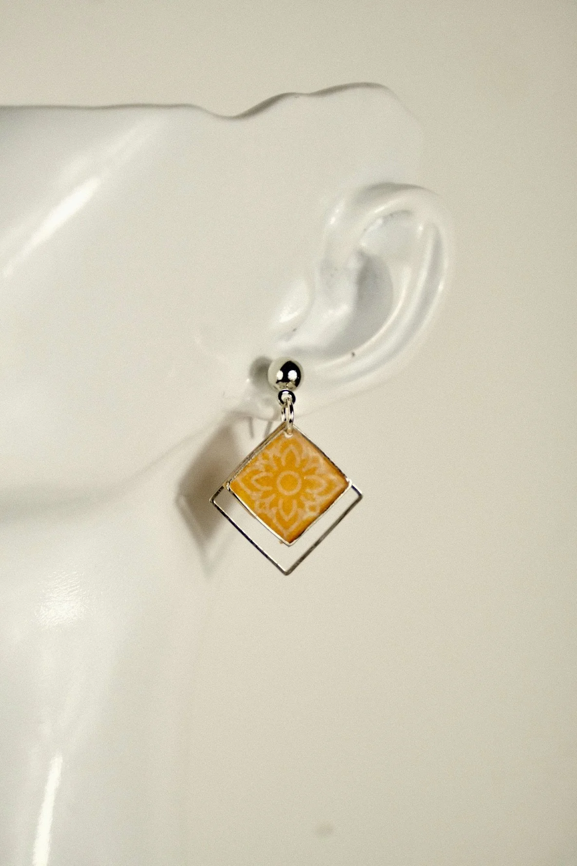 indigo roc floral orange resin earrings