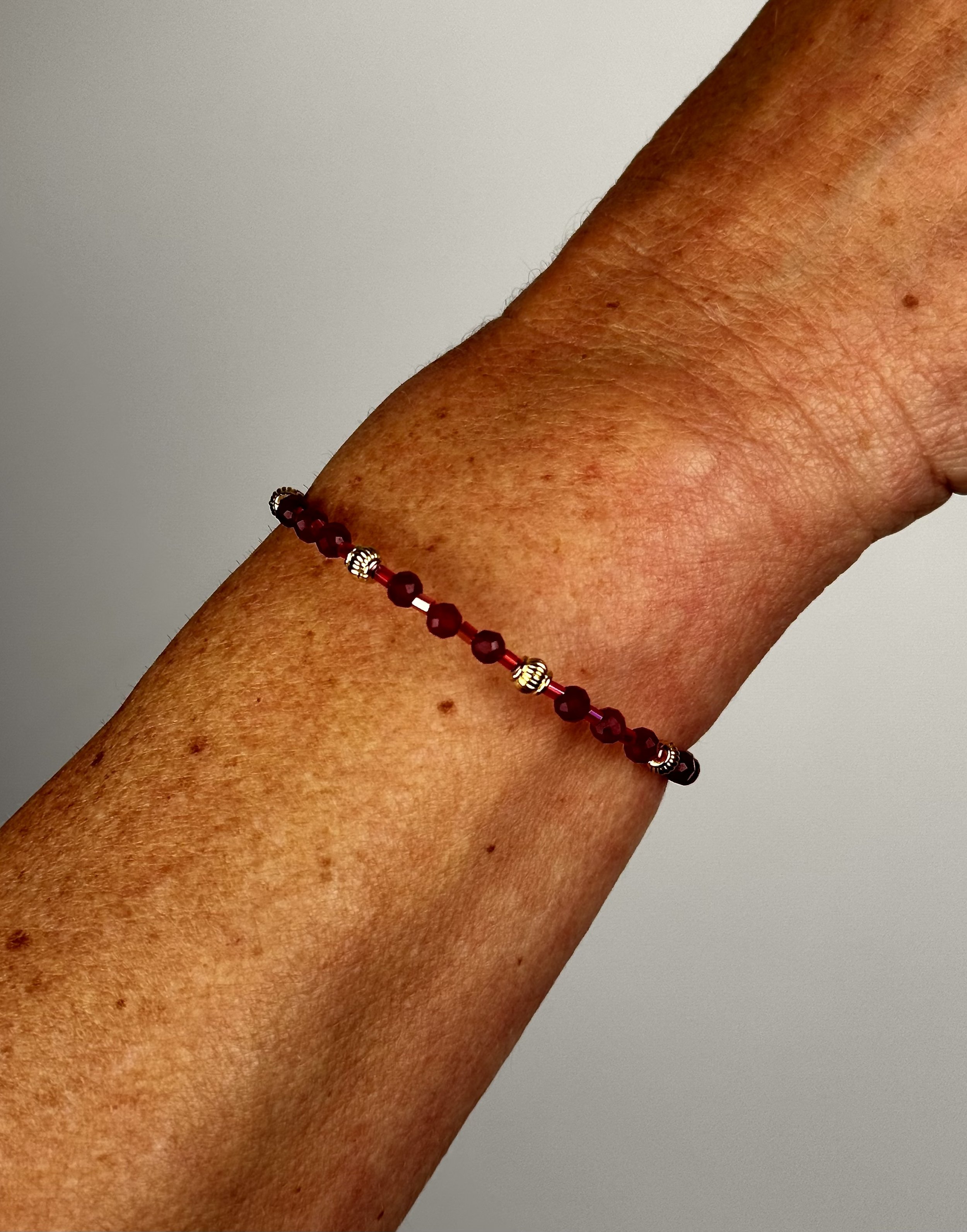 worn front view of open red berry bracelet