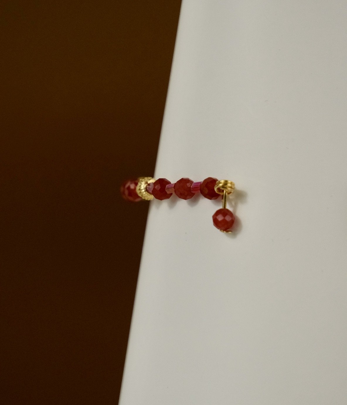 detailed side view of open red berry bracelet