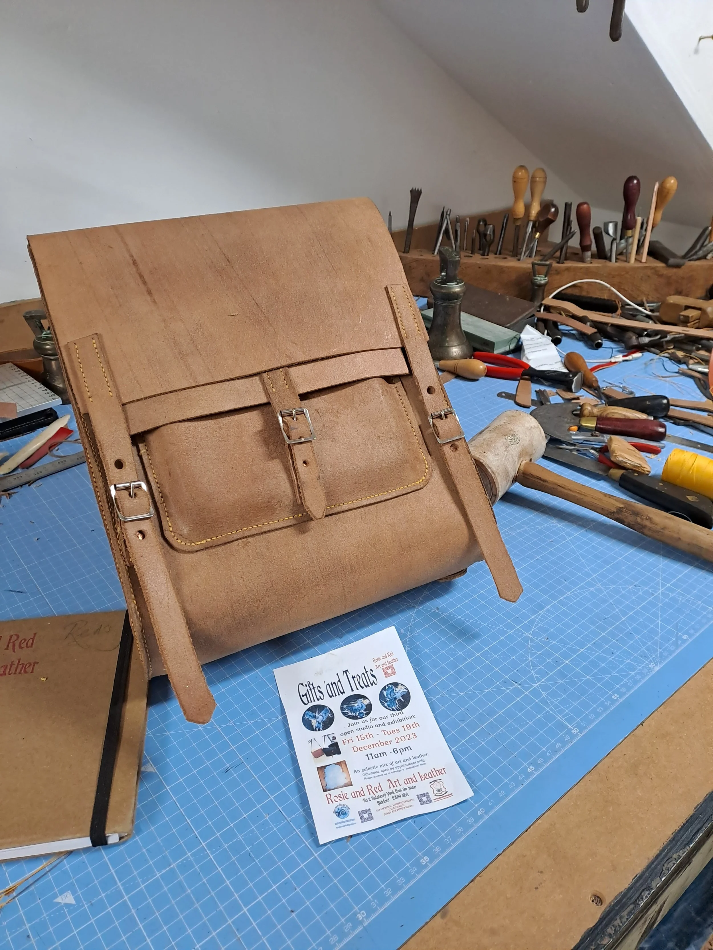 rosie and red art and heritage art print and leather classes and wokshops in the southwest bideford devon leathr back pack and heritage tools on  Reds studio  work bench