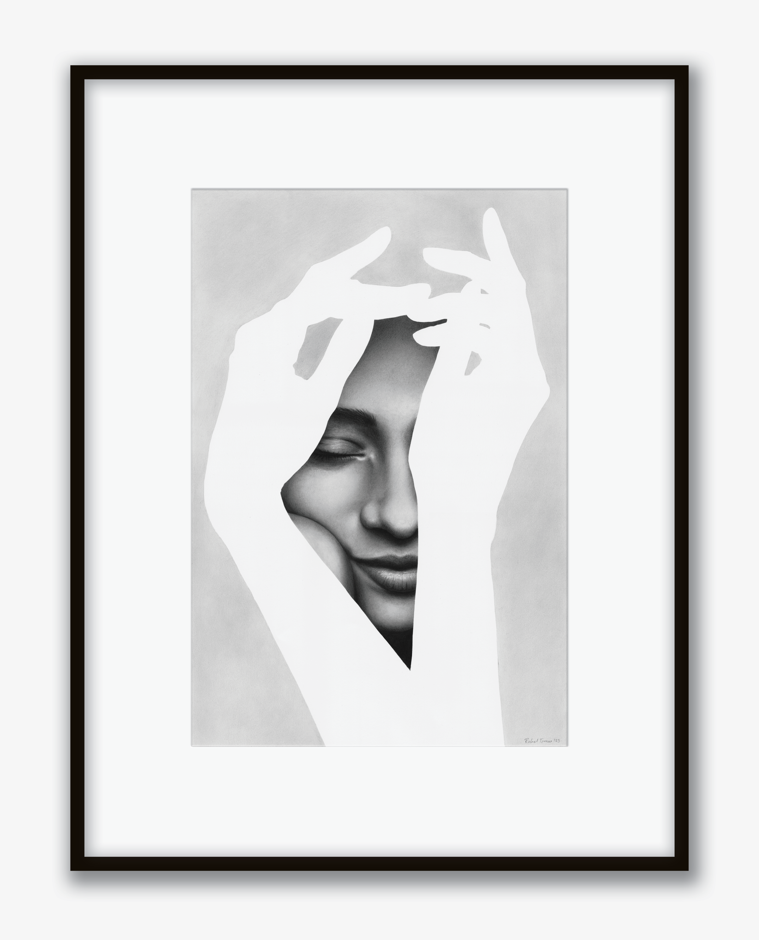 Black and white portrait of a woman smiling with eyes closed, partially covered by white hands forming an oval shape over her face, framed in black.