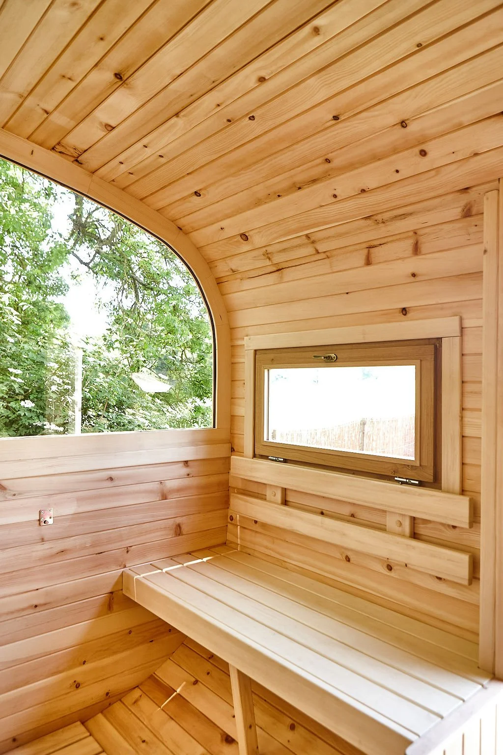 Warm room with wooden bench and window, attached to the sauna