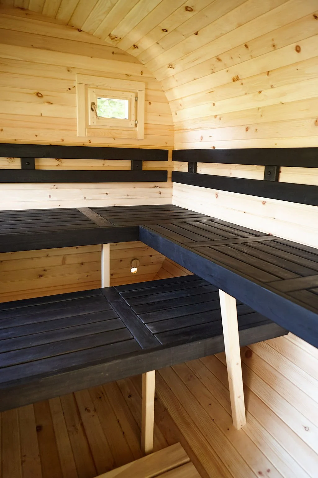 Inside the wood-fired sauna with wide wooden benches