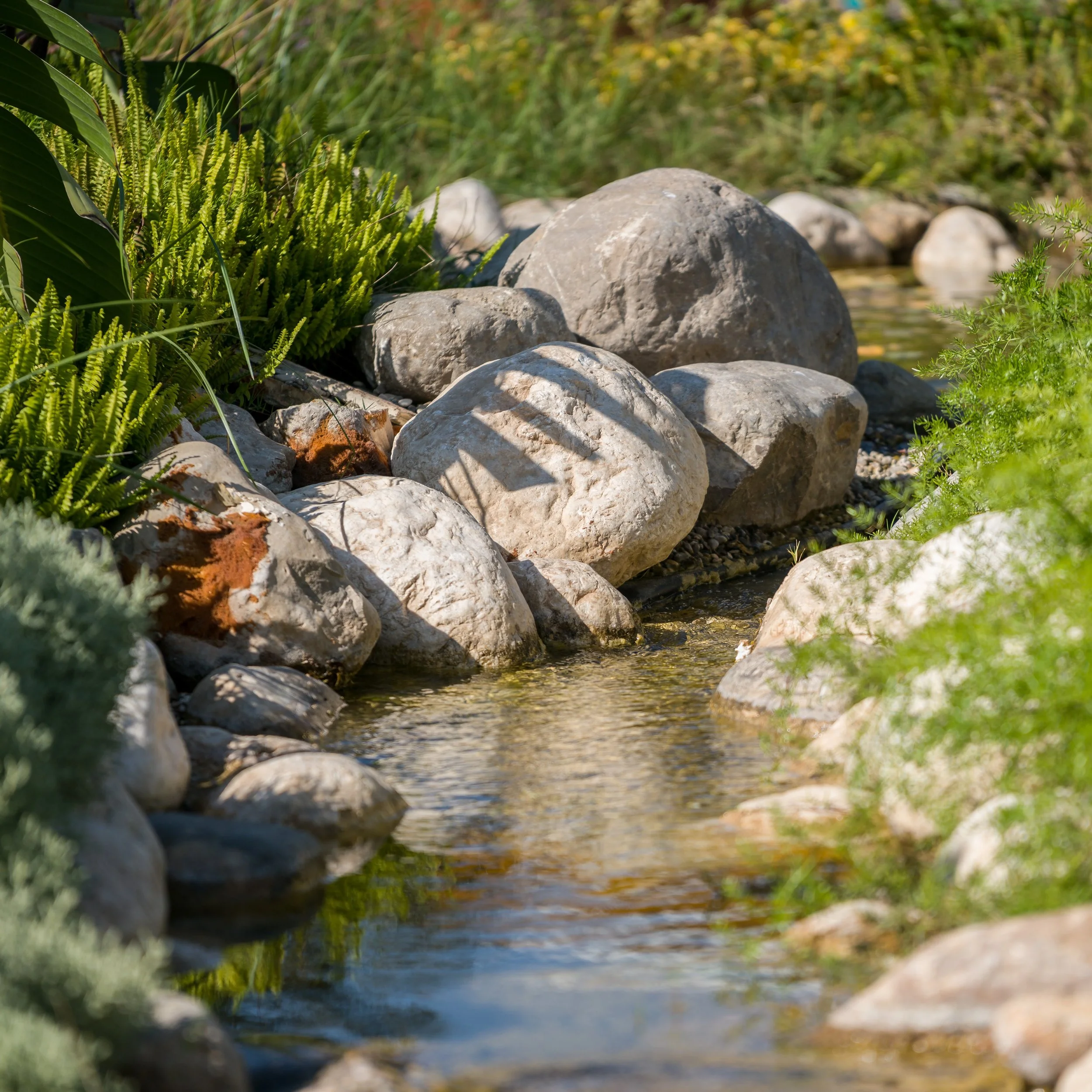 back yard-pond-stream-with-granite-boulders-naperville-illinois.jpg