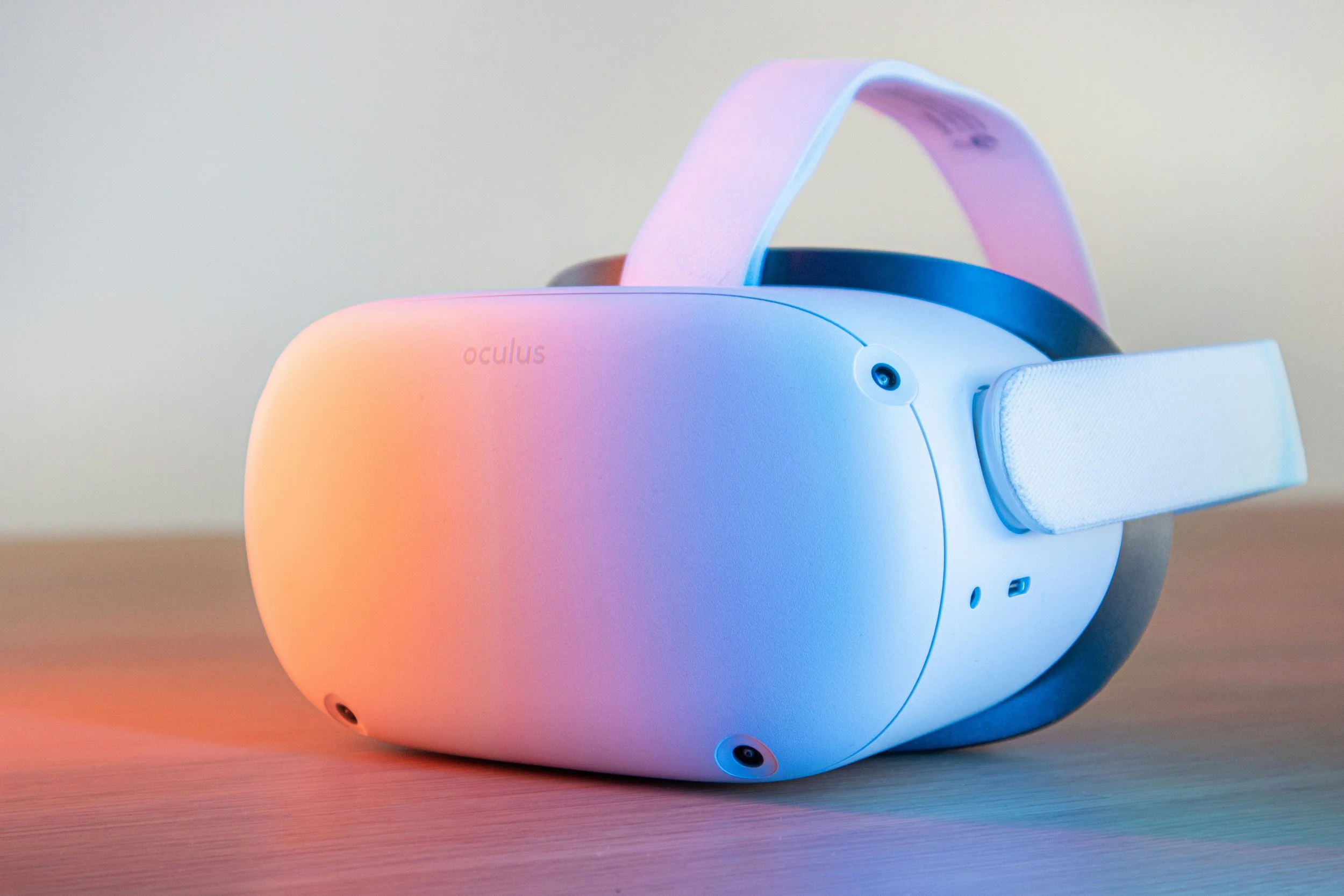 Stock photo of a virtual reality headset, which is lit up with orange, purple, and blue lights for a modern, clean aesthetic. Photo: Remy Gieling via Unsplash.