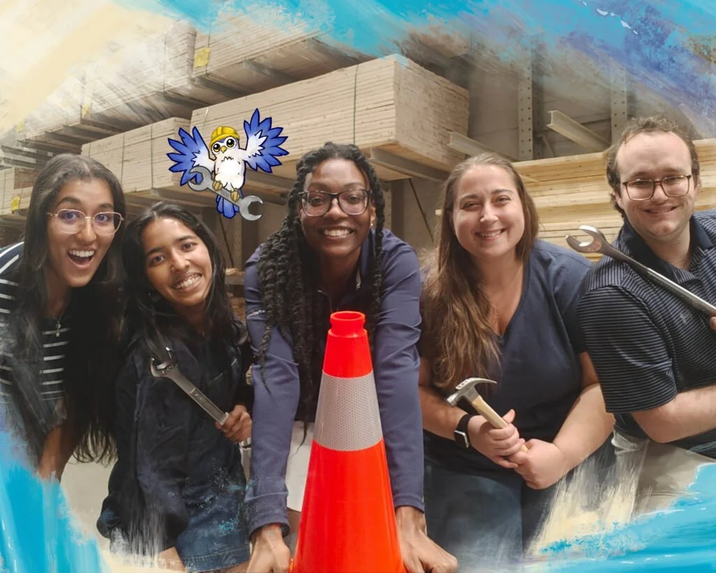 Photo of the Little Owl Construction Co. Team, including a cartoon drawing of Dawn the owl. Team members are holding building tools and posed in front of wood planks. Photo Credit: Little Owl Construction Co.