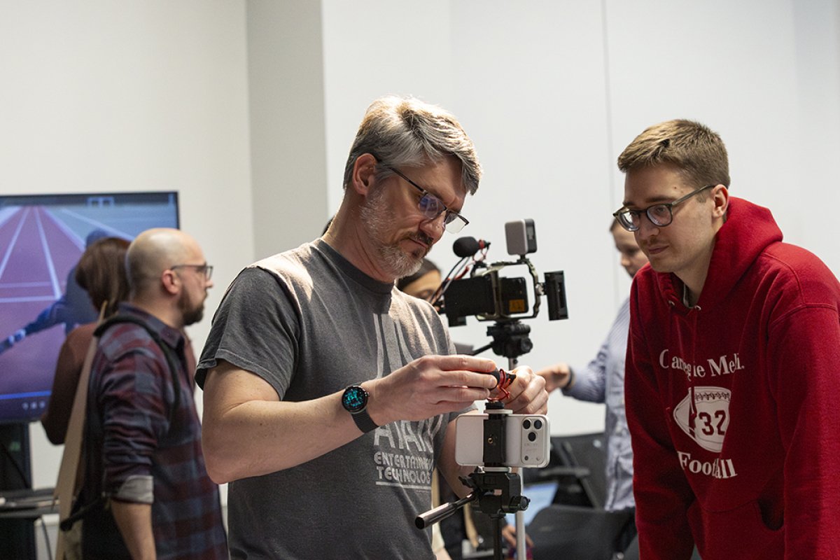 Director of Information Technology Steve Audia and Outreach and Engagement Network Coordinator Anthony Palyszeski prepare cameras for filming. Source: ETC.