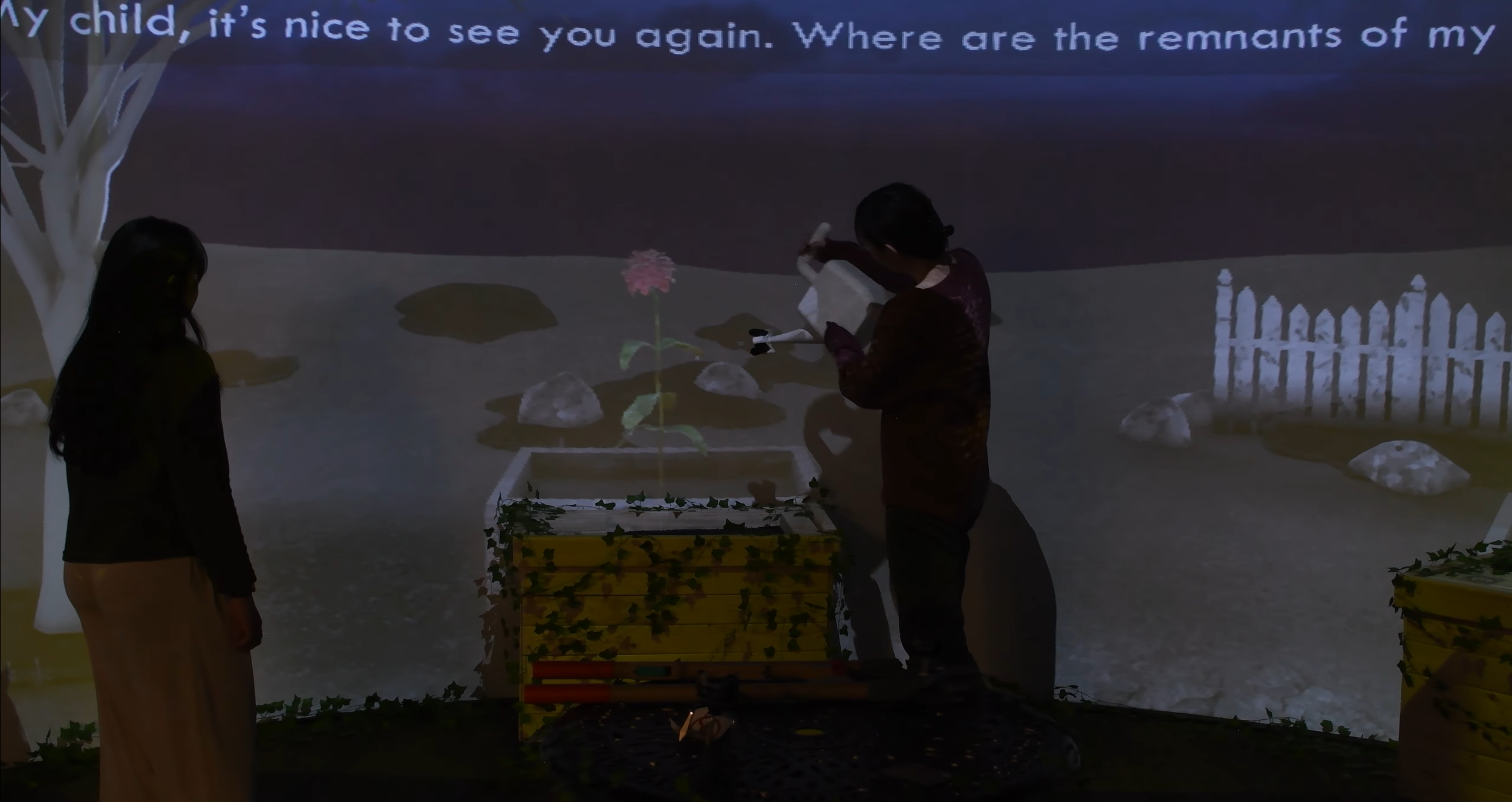 Screenshot of a scene from the Remnants experience. It shows two guests watering the wooden flower box. On the screen, a rose blooms. The rest of the screen is desaturated. Source of screenshot material: Remnants Team.