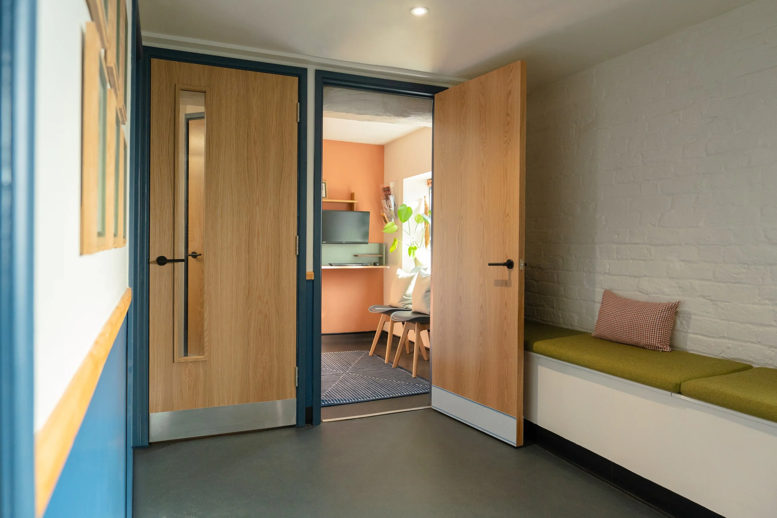 Bright veterinary waiting area with built-in bench seating, natural textures, and warm contemporary interiors at Malthouse Vets.