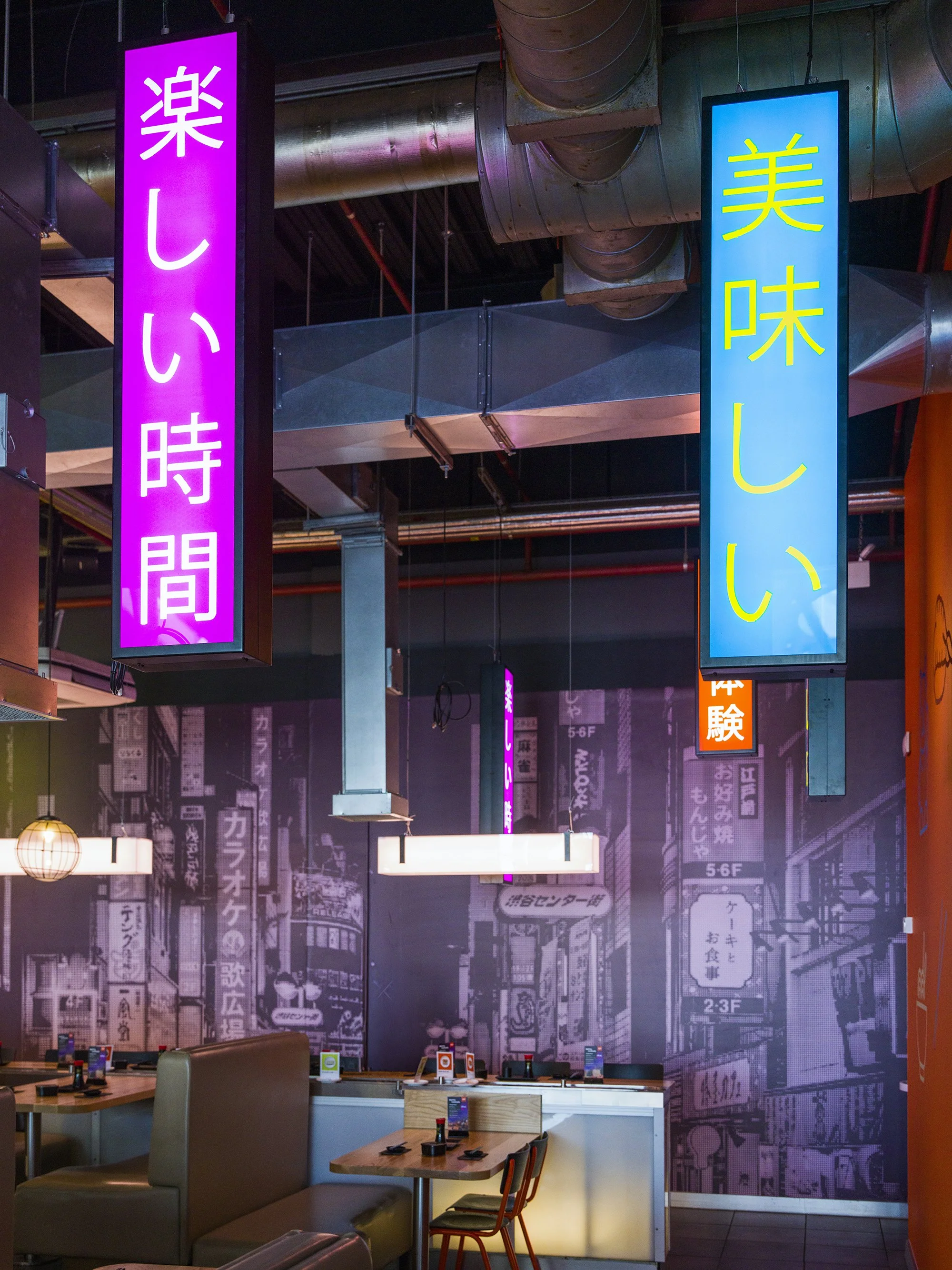 Contemporary Japanese restaurant wall graphics and neon signage creating a vibrant branded interior experience at YO! Aberdeen.