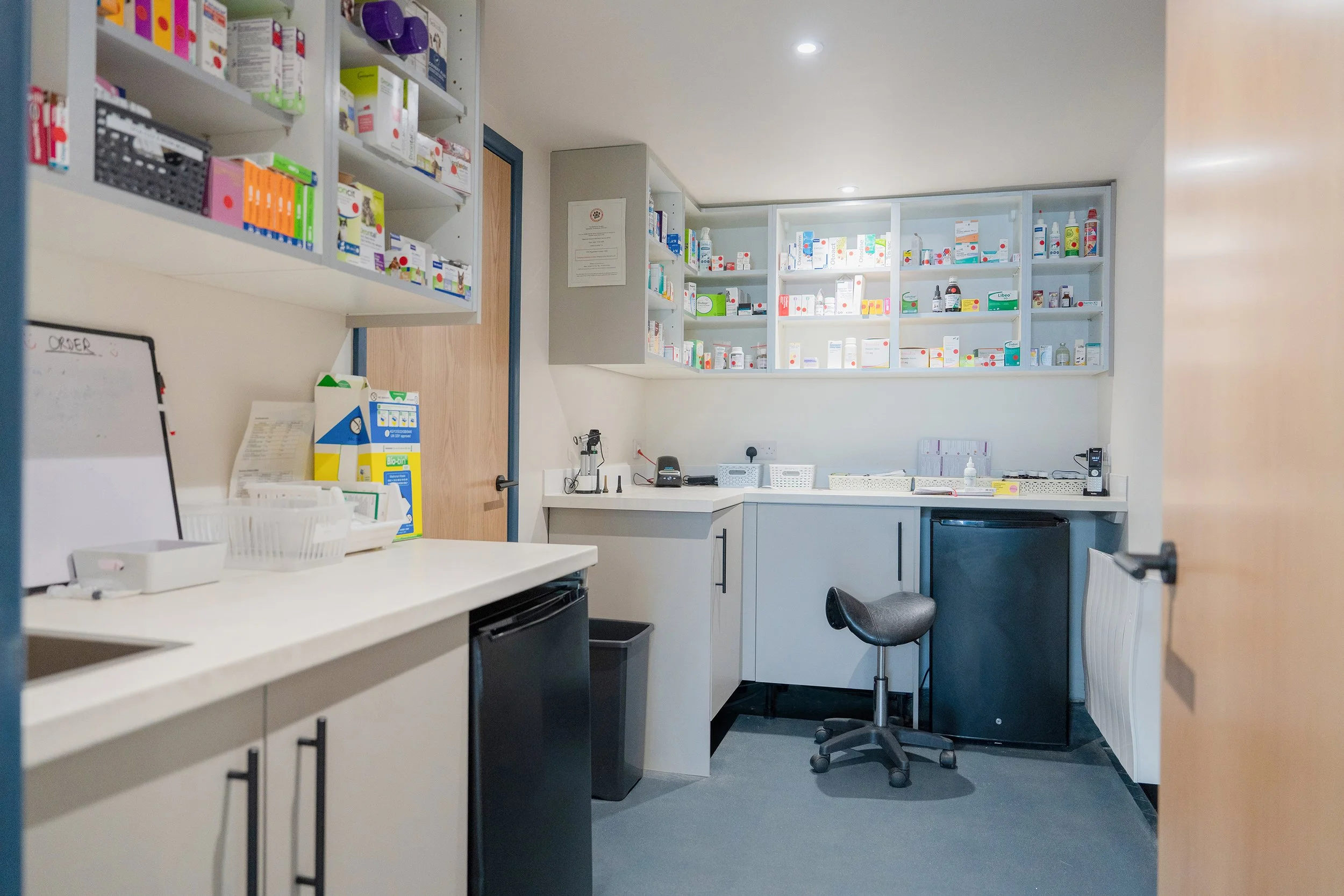 Contemporary veterinary treatment and dispensary area at Malthouse Vets with bespoke storage, bright clinical lighting, and organised medical workspace.