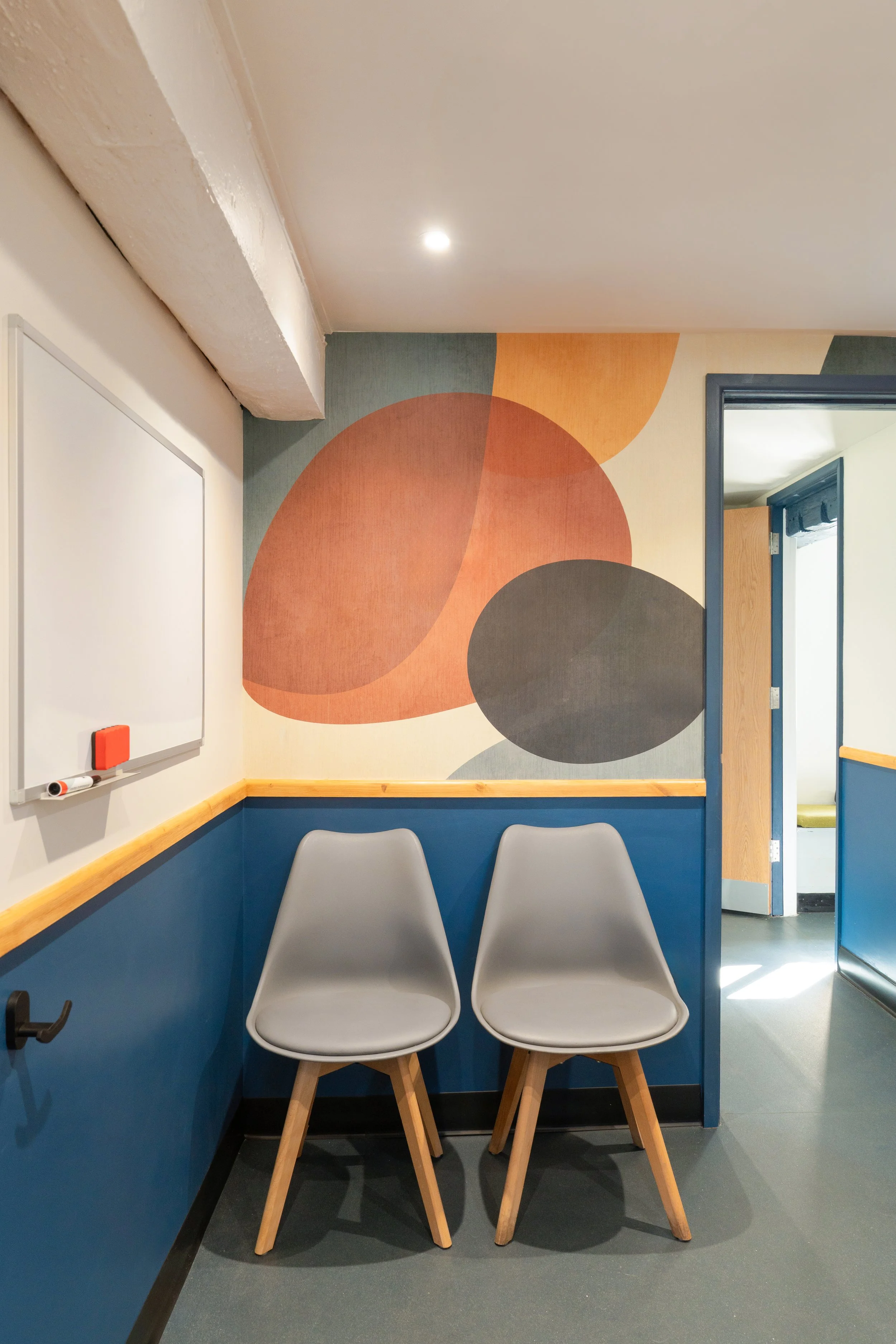 Welcoming waiting area at Malthouse Vets with bespoke seating, playful wall mural, and calming interior design for pets and owners.