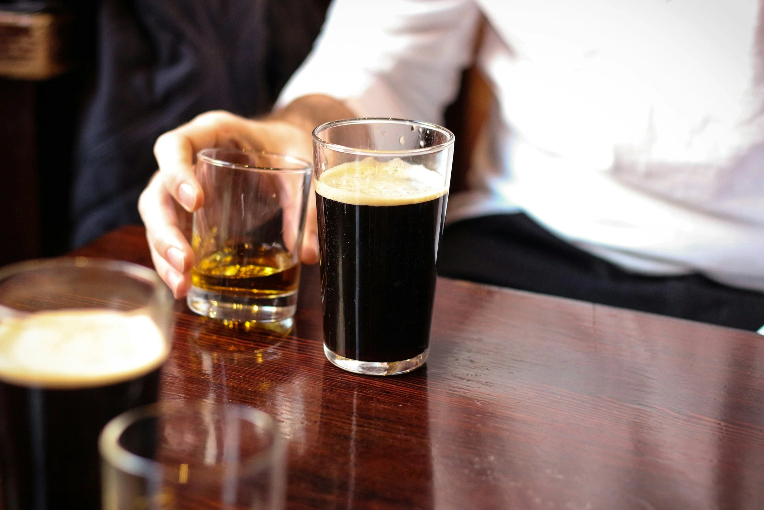 Person pouring a beer