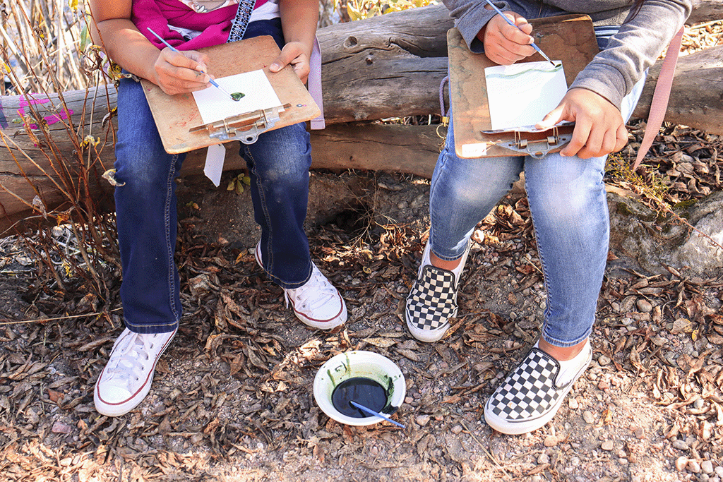 kids painting with algae watercolors outside for science outreach field trip